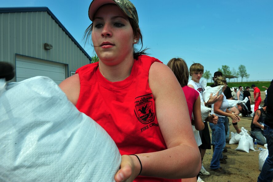 MINOT, N.D. -- Members of Team Minot work together to make sandbags at the Minot Public Works June 1 In preparation for possible flooding, the city of Minot, with assistance from Airmen from Minot Air Force Base, North Dakota National Guard as well as many other organizations, are setting up secondary dikes along the river. The Souris River threatens to break the levies already in place, thousands of Minot citizens, including military members, their families and DoD civilians, have been forced to evacuate the area.  (U.S. Air Force photo/Senior Airman Jesse Lopez)
