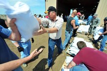MINOT, N.D. -- Members of Team Minot work together to make sandbags at the Minot Public Works June 1 In preparation for possible flooding, the city of Minot, with assistance from Airmen from Minot Air Force Base, North Dakota National Guard as well as many other organizations, are setting up secondary dikes along the river. The Souris River threatens to break the levies already in place, thousands of Minot citizens, including military members, their families and DoD civilians, have been forced to evacuate the area.  (U.S. Air Force photo/Senior Airman Jesse Lopez)