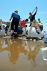 MINOT, N.D. -- Members of Team Minot work together to make sandbags at the Minot Public Works June 1 In preparation for possible flooding, the city of Minot, with assistance from Airmen from Minot Air Force Base, North Dakota National Guard as well as many other organizations, are setting up secondary dikes along the river. The Souris River threatens to break the levies already in place, thousands of Minot citizens, including military members, their families and DoD civilians, have been forced to evacuate the area.  (U.S. Air Force photo/Senior Airman Jesse Lopez)