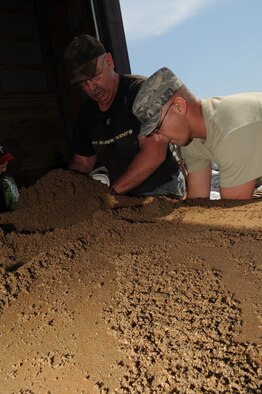 MINOT, N.D.-- Members of Team Minot work together to prepare sandbags for the incoming floods here June 1.  In preparation for possible flooding, the city of Minot, with assistance from Airmen from Minot Air Force Base, North Dakota National Guard as well as many other organizations, are setting up secondary dikes along the river. The Souris River threatens to break the levies already in place, thousands of Minot citizens, including military members, their families and DoD civilians, have been forced to evacuate the area.  (U.S. Air Force photo/Airman 1st Class Aaron-Forrest Wainwright)