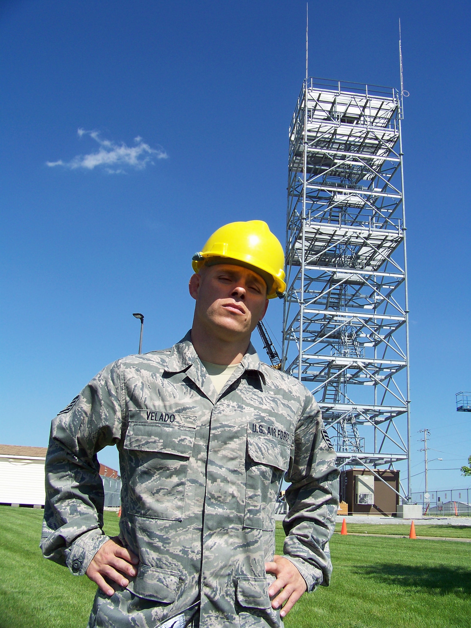 Staff Sgt. Tony Velado stands before a 100' bi-static radar tower May 20, 2011 at Springfield Air National Guard Base, Ohio. Air National Guard Airmen from engineering installation squadrons in six states helped construct four towers and install radar systems to provide the Air Force Research Laboratory at Wright-Patterson Air Force Base with the capability to conduct advanced sensors research. BRAC 2005 decisions directed relocation of the research radars to Wright-Patterson from Rome, N.Y.  Sergeant Velado briefly took a break during construction to become Ohio's middleweight Brazilian Jiu-jitsu champion.  He is with the 243rd Engineering Installation Squadron, based in South Portland, Maine. (U.S. Air Force photo/Derek Kaufman)