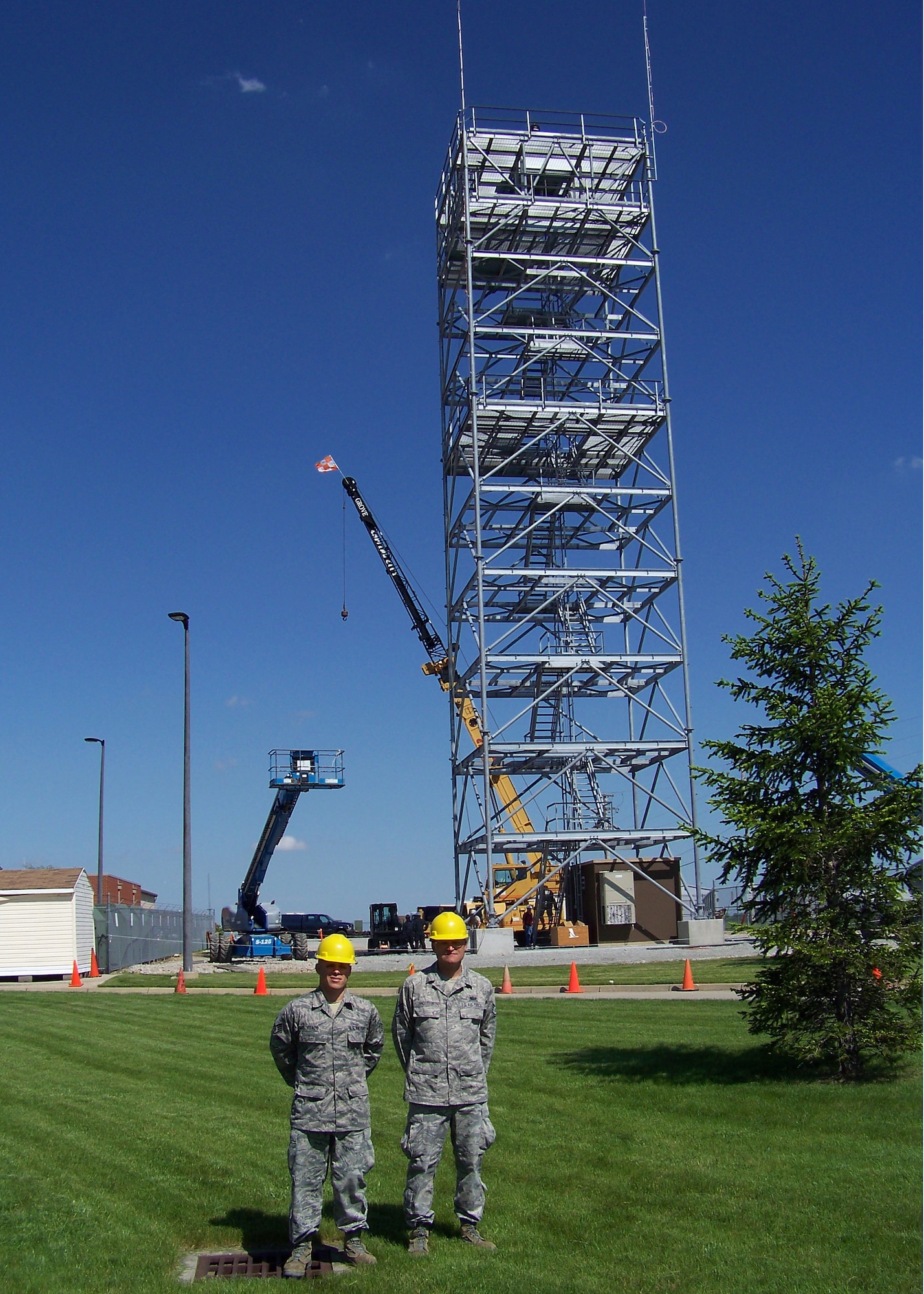 Staff Sgt. Tony Velado and Staff Sgt. Keith Anderson stand before a 100' bi-static radar tower May 20, 2011 at Springfield Air National Guard Base, Ohio. Air National Guard Airmen from engineering installation squadrons in six states helped construct four towers and install radar systems to provide the Air Force Research Laboratory at Wright-Patterson Air Force Base with the capability to conduct advanced sensors research. BRAC 2005 decisions directed relocation of the research radars to Wright-Patterson from Rome, N.Y.  Both Guardsmen are with the 243rd Engineering Installation Squadron, based in South Portland, Maine. (U.S. Air Force photo/Rick Shaughnessy)