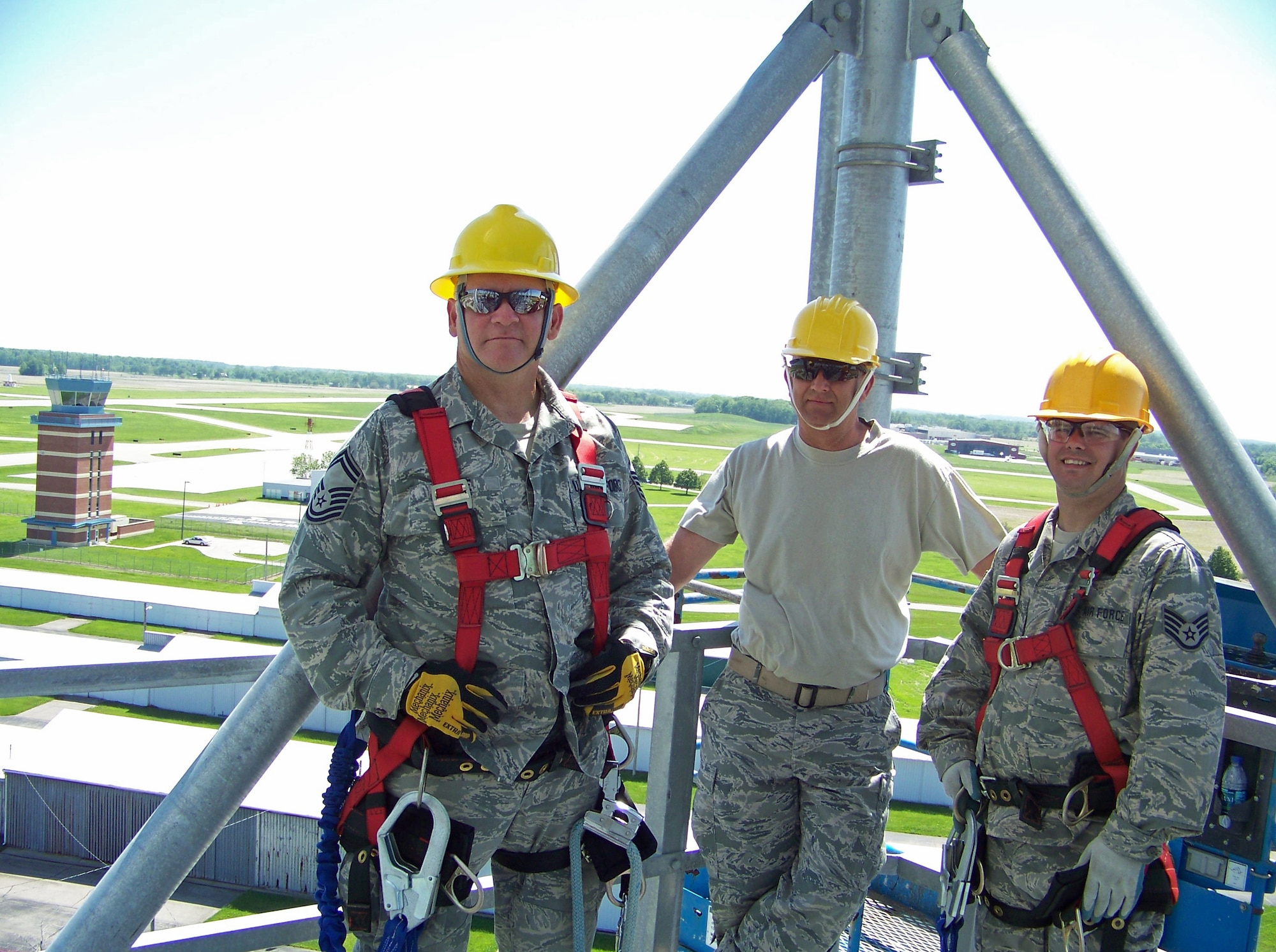 Senior Master Sgt. Michael Pope, Master Sgt. Peter Krug and Staff Sgt. Lynn Shain take a break during construction of a 100' bi-static radar tower May 20, 2011 at Springfield Air National Guard Base, Ohio.  Air National Guard Airmen from six states helped construct four towers and install radar systems to provide the Air Force Research Laboratory at Wright-Patterson Air Force Base with the capability to conduct advanced sensors research. BRAC 2005 decisions directed relocation of the research radars from Rome, N.Y. Sergeant Pope is with the 219th Engineering Installation Squadron, based in Tulsa, Okla. Sergeants Krug and Shain are each with the 243rd Engineering Installation Squadron, South Portland, Maine. (U.S. Air Force photo/Rick Shaughnessy)