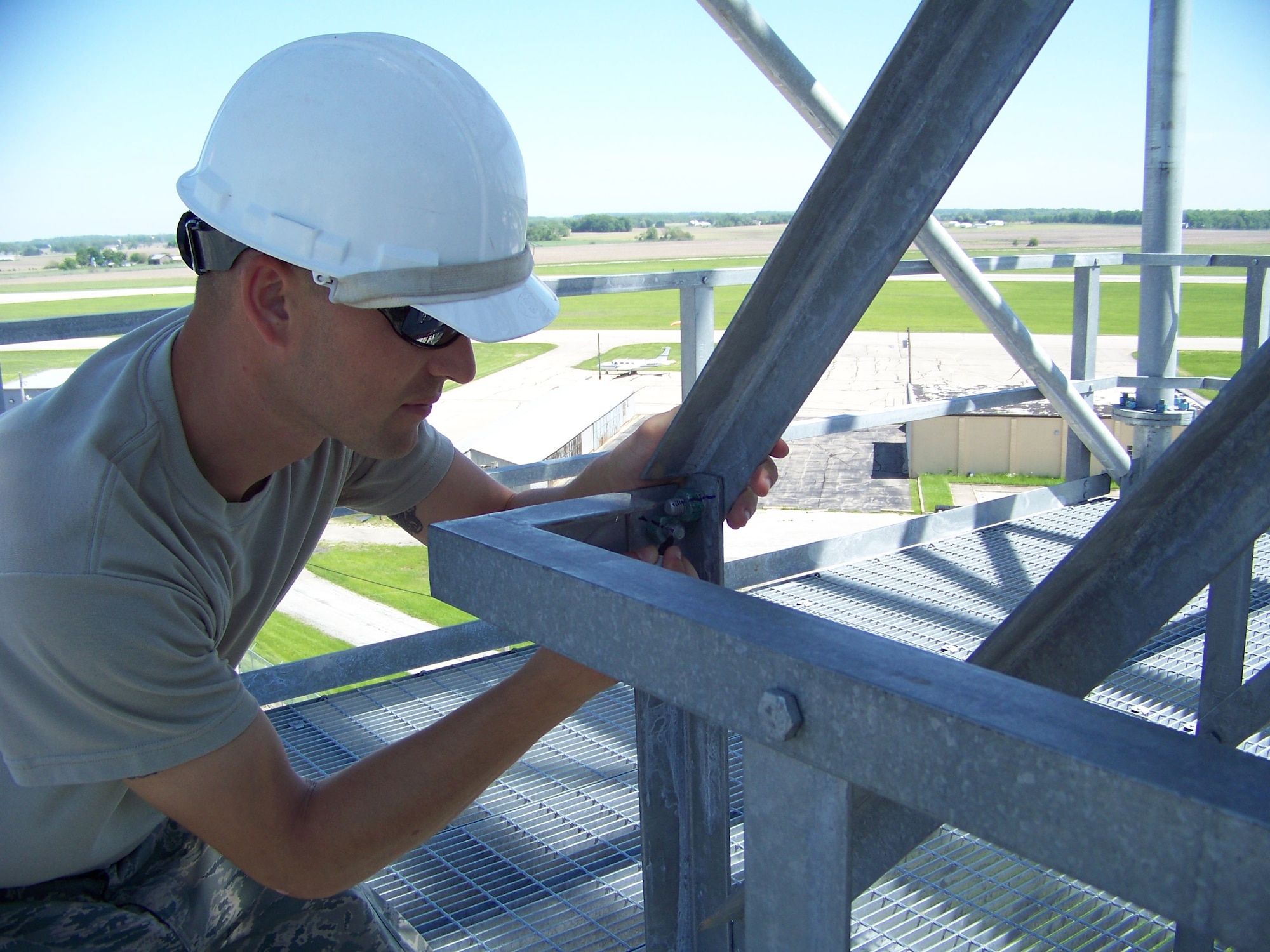 Tech. Sgt. Brian McCarty marks a properly tightened bolt and nut during construction of a 100' radar tower May 20, 2011 at Springfield Air National Guard Base, Ohio.  Air National Guard Airmen from six states helped construct four towers and install radars to provide the Air Force Research Laboratory at Wright-Patterson Air Force Base with the capability to conduct advanced sensors research. BRAC 2005 decisions directed relocation of the research radars from Rome, N.Y. Sergeant McCarty is with the 220th Engineering Installation Squadron, based in Zanesville, Ohio. (U.S. Air Force photo/Rick Shaughnessy)