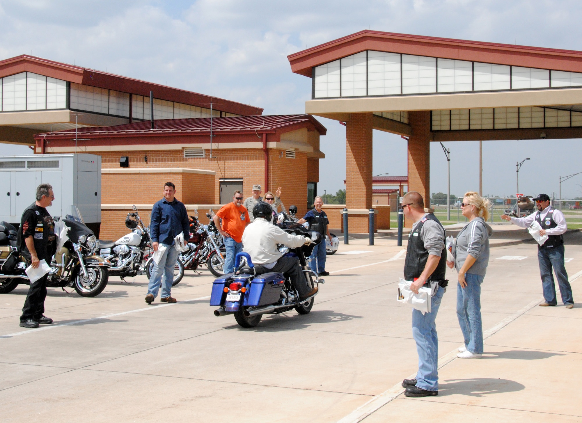 The Vance chapter of the Green Knights Motorcycle Club was on hand May 27 at the main gate wishing Team Vance members a safe and fun Memorial Day Weekend. The Green Knights handed out safety material that included “Buckle up for Safety” buckles, stickers and a mini license plate. (U.S. Air Force photo/ Zach Sproul) 