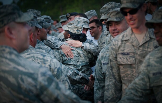 Members of the 823rd Base Defense Squadron give their goodbyes to the deploying Airmen at Moody Air Force Base, Ga. After receiving their goodbyes, the deploying Airmen loaded onto a bus and began their deployment to Afghanistan. (U.S. Air Force photo/Airman 1st Class Douglas Ellis)(RELEASED)
