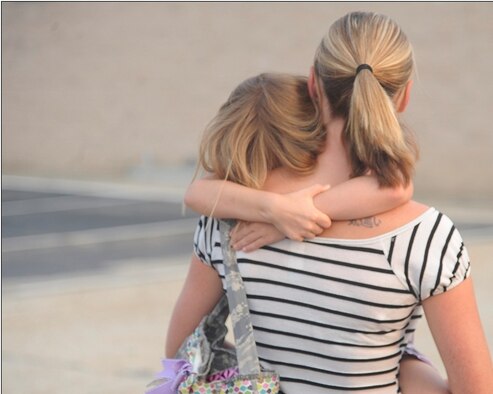 Madison and Heather Watts walk away as they say goodbye to 2nd Lt. Shane Watts, 823rd Base Defense Squadron member as he was boarding the bus to deploy from Moody Air Force Base, Ga. The 823rd BDS Airmen deployed for about six months to Afghanistan. (U.S. Air Force photo/Airman 1st Class Paul Francis)(RELEASED)