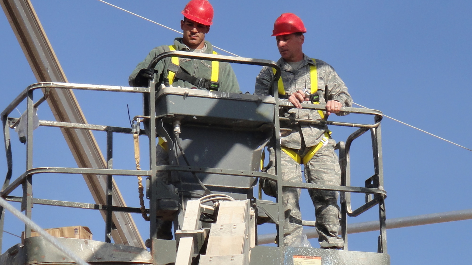 Chaplain (Capt.) Mark Nevius assists during crane operation in Afghanistan. Chaplain Nevius is the 1st Expeditionary RED HORSE Group chaplain. Chaplain Nevius and Staff Sgt. Todd Hankey deploy to the various RED HORSE locations to meet the spiritual needs of service members downrange. Sergeant Hankey is a chaplain's assistant. (U.S. Air Force photo/Staff Sgt. Todd Hankey)