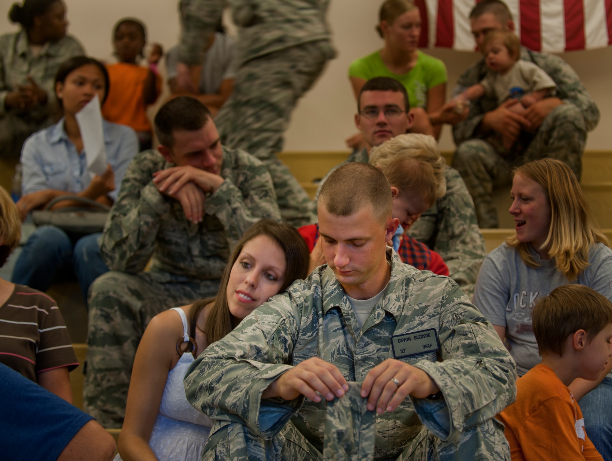 1st Lt. Devon Bledsoe, 823rd Base Defense Squadron member, sits beside his wife before deploying at Moody Air Force Base, Ga. Members of the 823rd BDS waited in an auditorium before departing on their deployment to Afghanistan. (U.S. Air Force photo/Airman 1st Class Douglas Ellis)(RELEASED)
