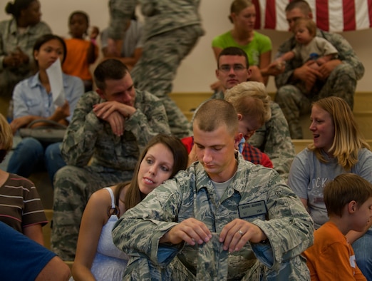 1st Lt. Devon Bledsoe, 823rd Base Defense Squadron member, sits beside his wife before deploying at Moody Air Force Base, Ga. Members of the 823rd BDS waited in an auditorium before departing on their deployment to Afghanistan. (U.S. Air Force photo/Airman 1st Class Douglas Ellis)(RELEASED)
