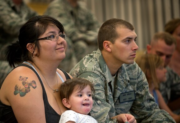 Staff Sgt. Josh Wells, 823rd Base Defense Squadron member, sits with his family before deploying to Afghanistan at Moody Air Force Base, Ga. Col. Randall Richert, 820th Base Defense Group commander, briefed the Airmen and their families on their upcoming mission. (U.S. Air Force photo/Airman 1st Class Douglas Ellis)(RELEASED)
