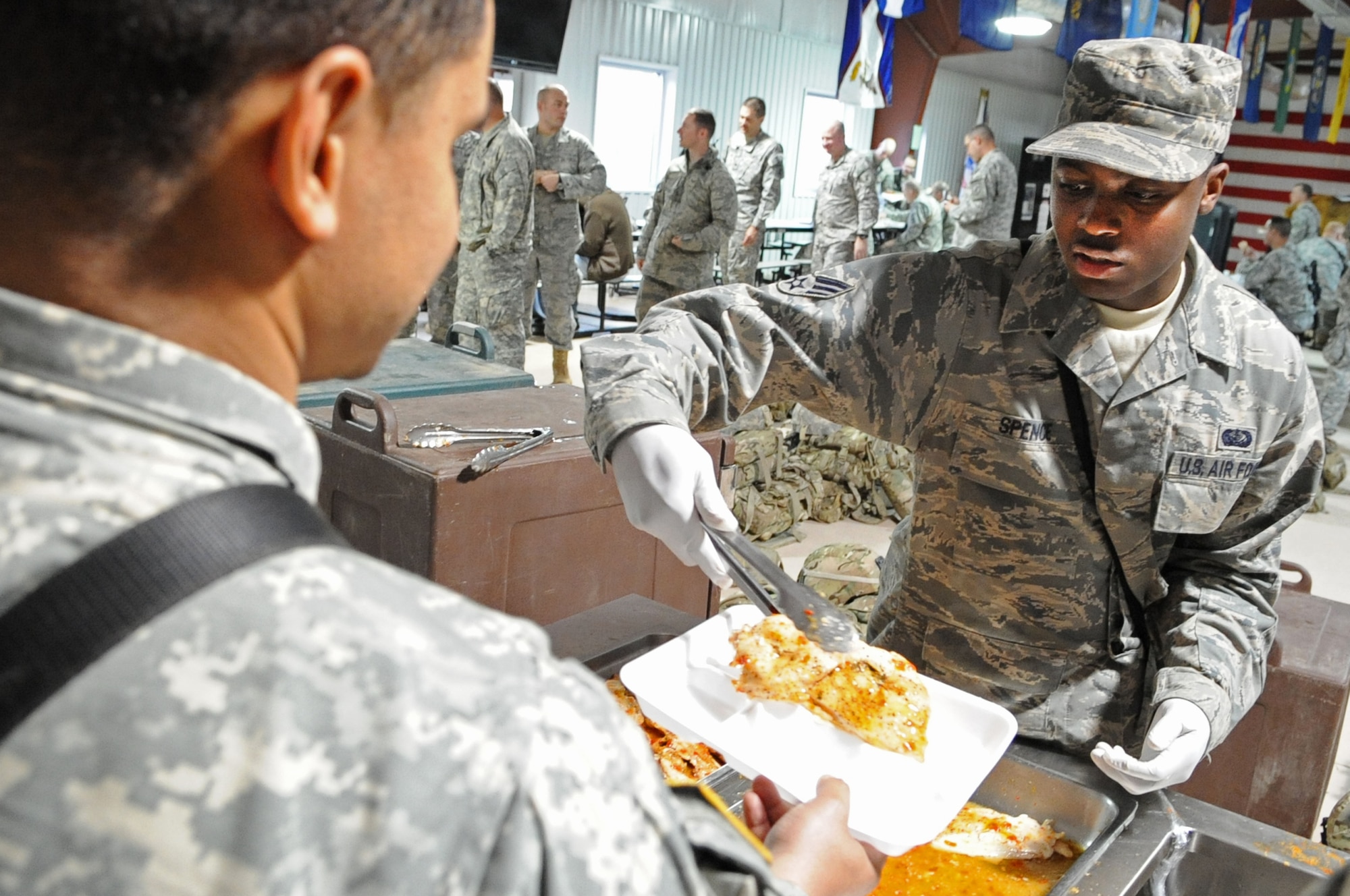 Senior Airman Leon Spence serves hot chow to a member of Provincial Reconstruction Team Paktya during a field training event. PRT Paktya Warriors are scheduled to deploy in support of Operation Enduring Freedom this summer. (U.S. Air Force photo/ Senior Airman Wesley Farnsworth) 