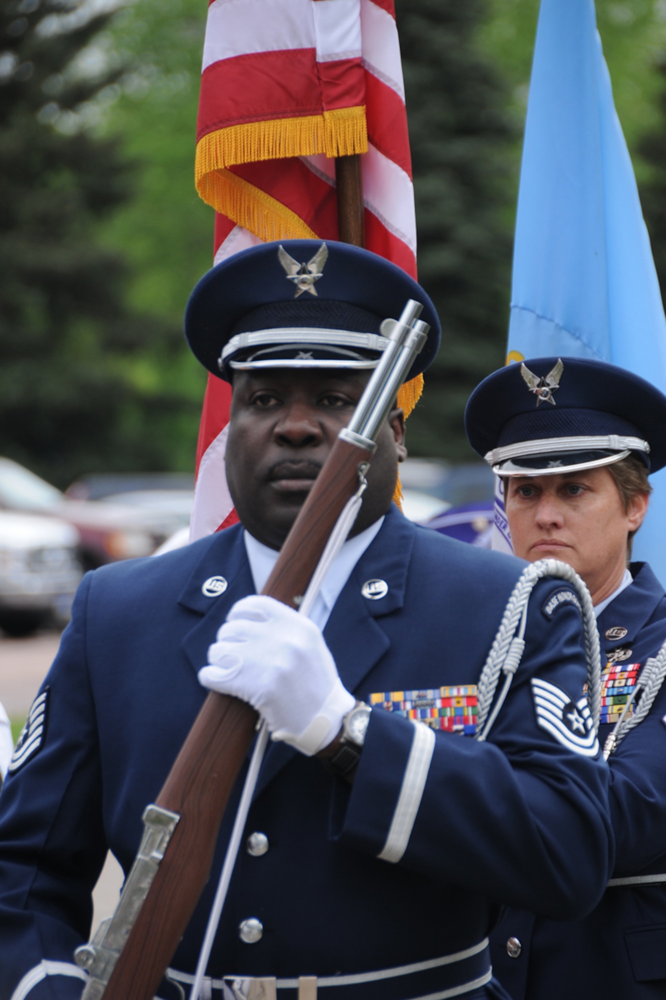 SIOUX FALLS, SD - Master Sgt. Lisa Eisenhauer and Technical Sgt. Theron Liggons, members of the 114th Fighter Wing Honor Guard, present the colors during the Armed Forces Day ceremony held at the Sioux Falls Regional Veterans Administration Hospital on May 21.  The annual event brings members of several services together to recognize both current and past members of the military. (Air Force photo by Master Sgt. Nancy Ausland, RELEASED)