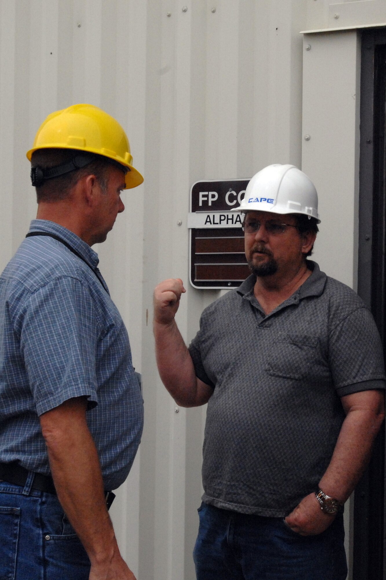 GRISSOM AIR RESERVE BASE, Ind., -- Tom Lennon, chief construction manager with the 434th Civil Engineer Squadron, left, talks to a contractor doing work on Bldg. 420, the  base motor pool. (U.S. Air Force photo/Staff Sgt. Carl Berry)