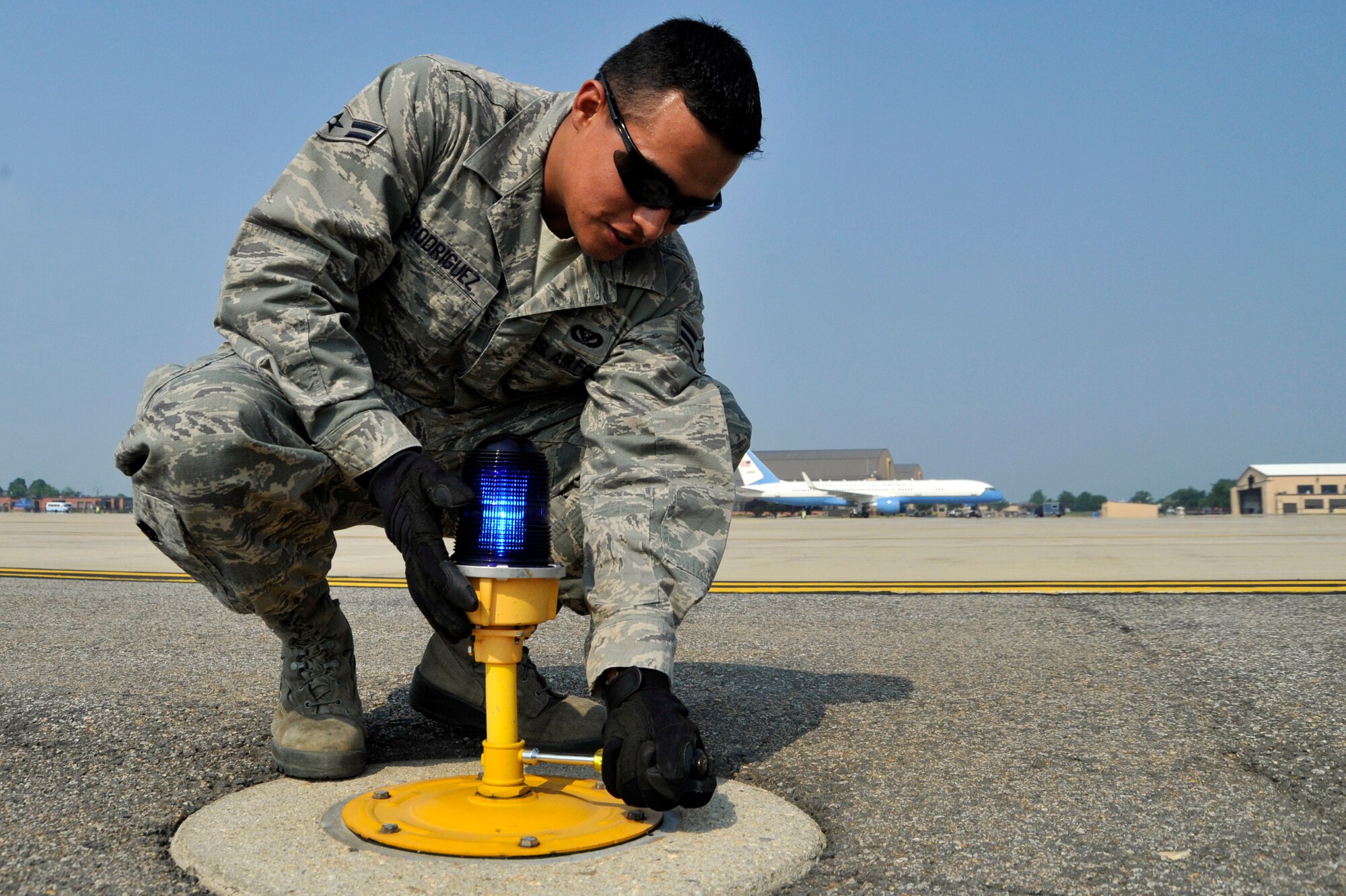 Airman 1st Class Erick Rodriguez, 11th CES electrical systems apprentice, replaces the taxiway edge light, June 1, 2011 at Joint Base Andrews, Md. The Airmen of 11th CES airfield lighting maintain all the lights and their electrical systems on the flightline. (U.S. Air Force photo/Senior Airman Perry Aston) 