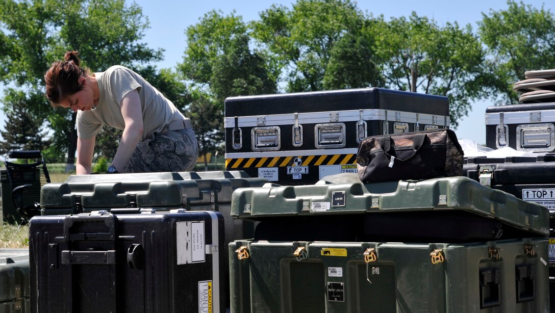Senior Airman Kelsey Morse, 621st Contingency Response Wing cyber transport technician, prepares communication equipment for redeployment at Mihail Kogalniceanu Air Base, Romania, May 27.  Fifty-four members of the 621st Contingency Response Wing deployed here May 9 to extend airfield capability supporting an airfield closure in the region and a U.S. Transportation Command multi-modal proof-of-principle evaluation. The Airmen moved more than 850 tons of cargo into and out of Afghanistan during the three-week operation.  (U.S. Air Force photo by Master Sgt. Laura K. Deckman/released)