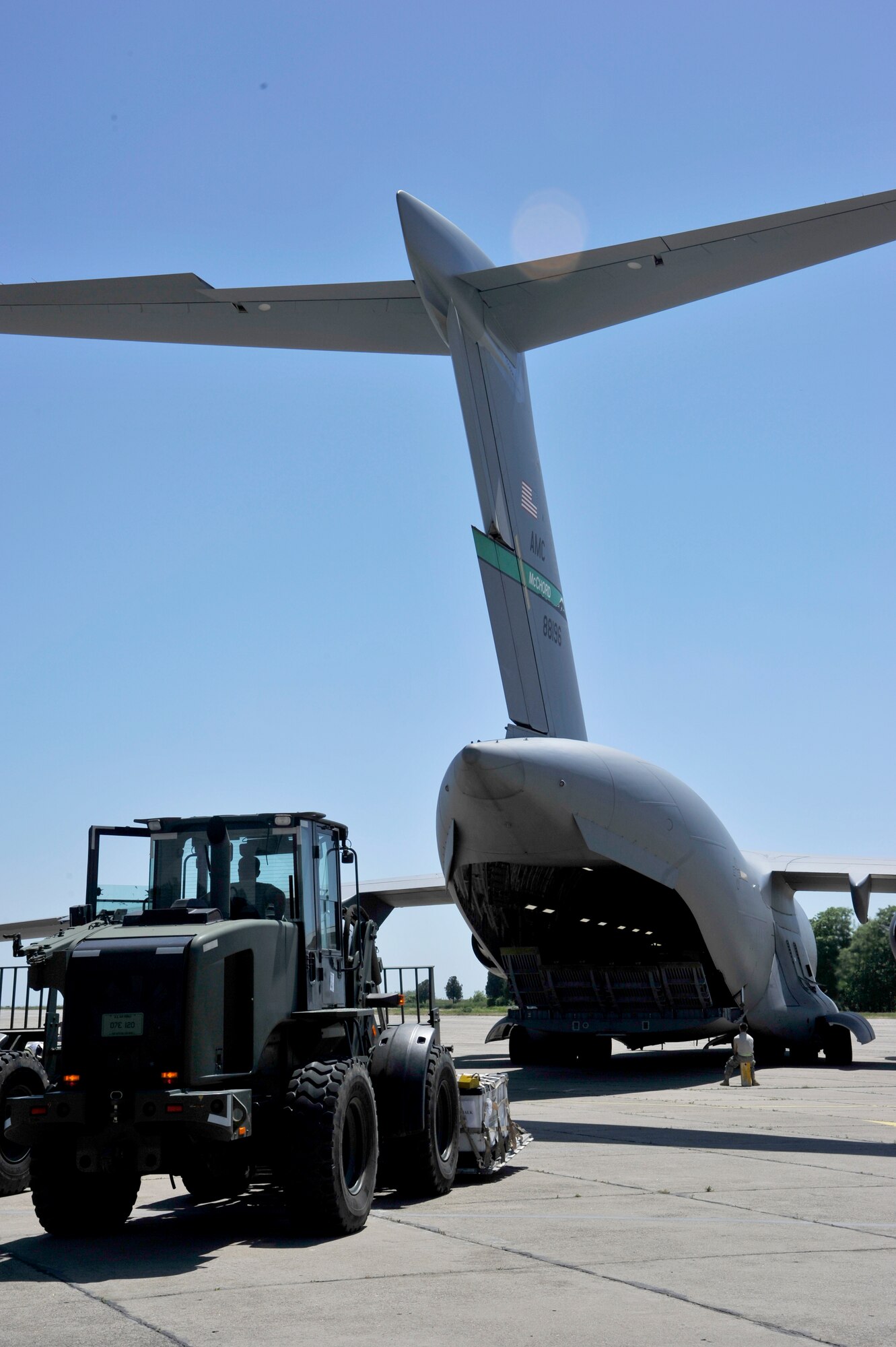 Members of the 621st Contingency Response Element load a C-17 Globemaster III during redeployment operations at Mihail Kogalniceanu Air Base, Romania, May 27.  Fifty-four members of the 621st Contingency Response Wing deployed here May 9 to extend airfield capability supporting an airfield closure in the region and a U.S. Transportation Command multi-modal proof-of-principle evaluation. The Airmen moved more than 850 tons of cargo into and out of Afghanistan during the three-week operation.  (U.S. Air Force photo by Master Sgt. Laura K. Deckman/released)