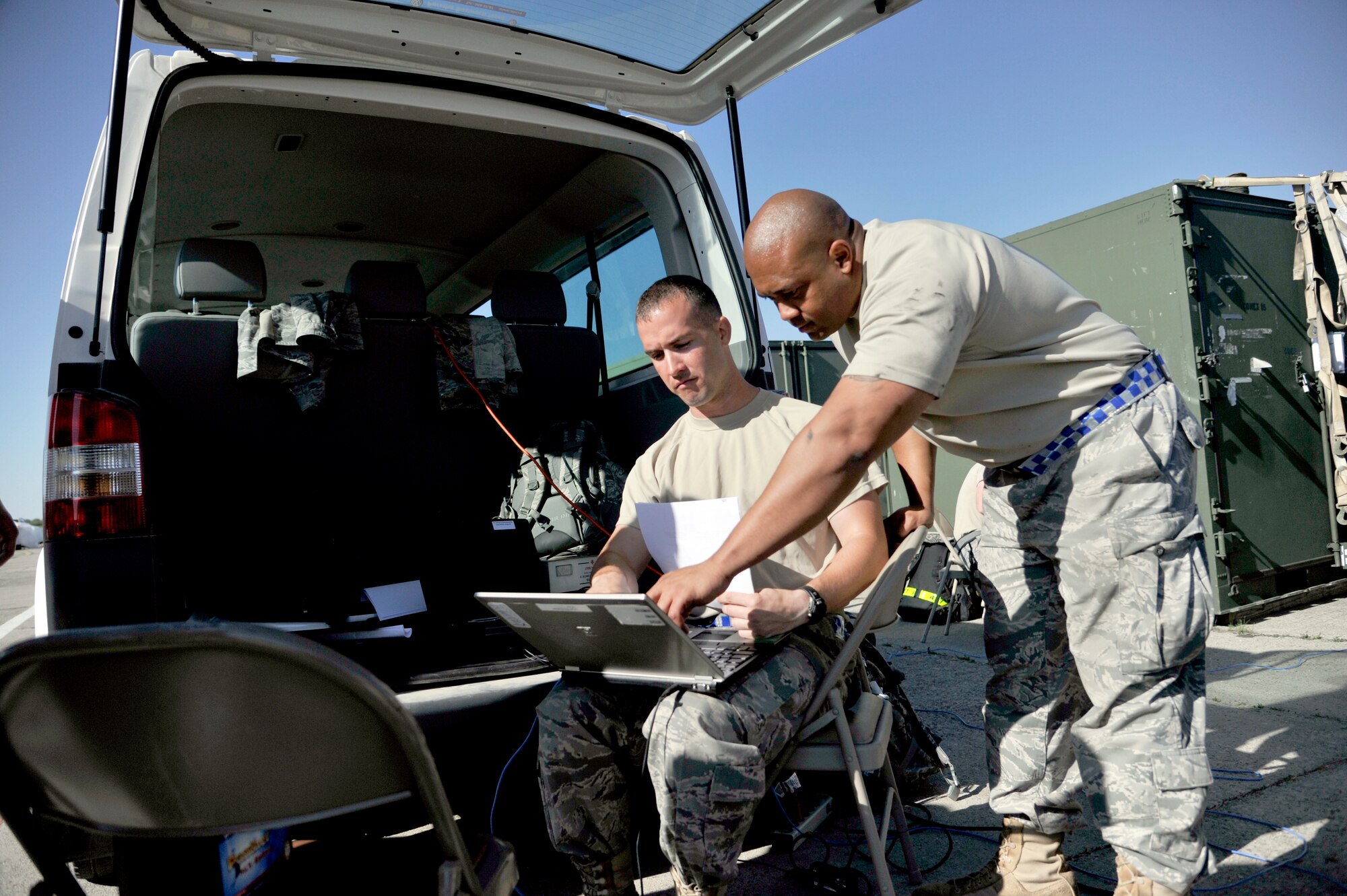 Senior Airman Christopher McCaskill (left) and Staff Sgt. Lyzander Jones, 621st Contingency Response Wing air transportation specialists, prepare load plans for redeployment operations at Mihail Kogalniceanu Air Base, Romania, May 27.  Fifty-four members of the 621st Contingency Response Wing deployed here May 9 to extend airfield capability supporting an airfield closure in the region and a U.S. Transportation Command multi-modal proof-of-principle evaluation. The Airmen moved more than 850 tons of cargo into and out of Afghanistan during the three-week operation.  (U.S. Air Force photo by Master Sgt. Laura K. Deckman/released)
