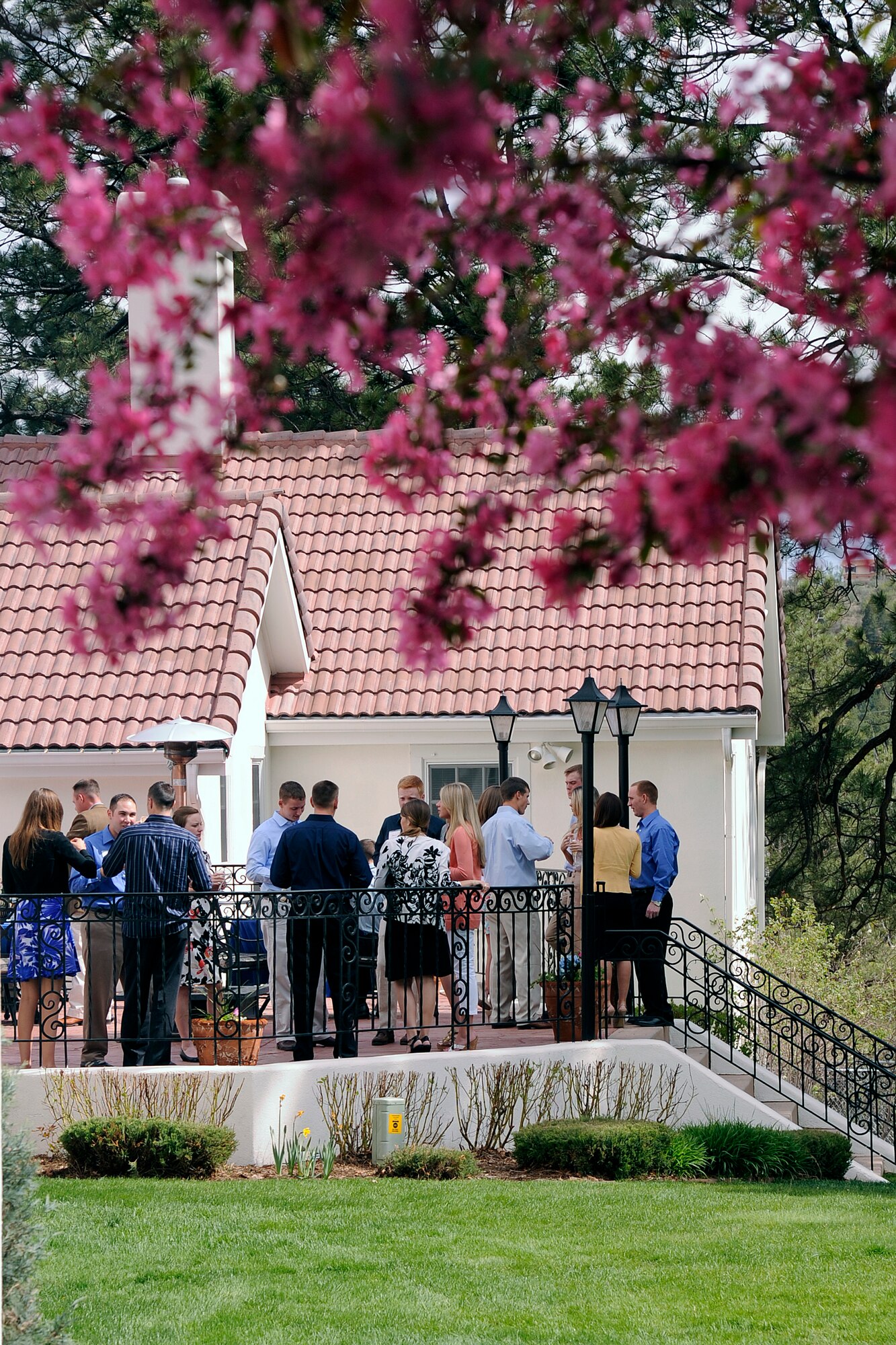 Cadets and their dates mingle on the back porch of the Air Force Academy's Otis House, official residence of the commandant of cadets.  (U.S. Air Force Photo/Ray McCoy)