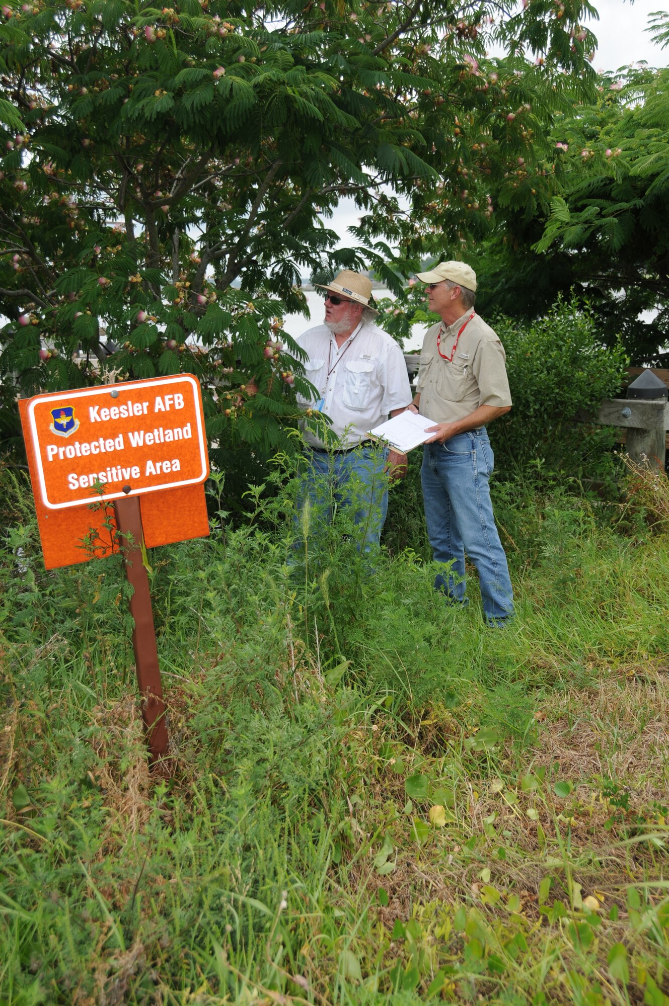 Phillip Remel, left, and Terry James, contractors with the base’s operating support contract, survey Keesler’s sensitive wetlands behind Bay Ridge housing area. Mr. Remel is taking inventory of the trees and vegetation that must be removed to preserve the wetlands. Mr James is monitoring the process to ensure no damage is being done to the wetlands.  (U.S. Air Force photo by Kemberly Groue)