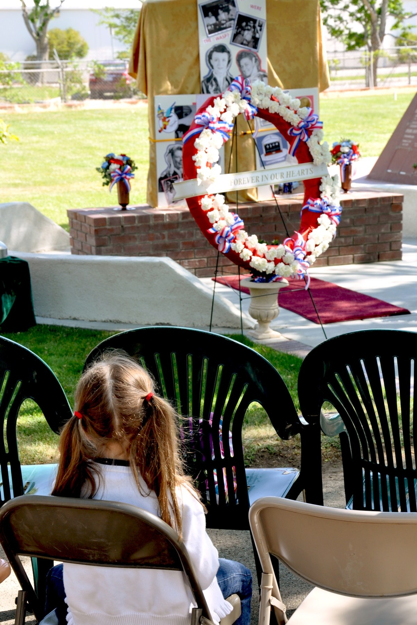 A young Antelope Valley resident takes in the memorials before Monday's ceremony honoring the Women Airforce Service Pilots. Many young women were among the more than 250 attendees who spent time visiting with the surviving WASPs and Col. Dawn M. Dunlop, 412th Test Wing Commander, receiving autographs, posing for photos and talking about flying.
