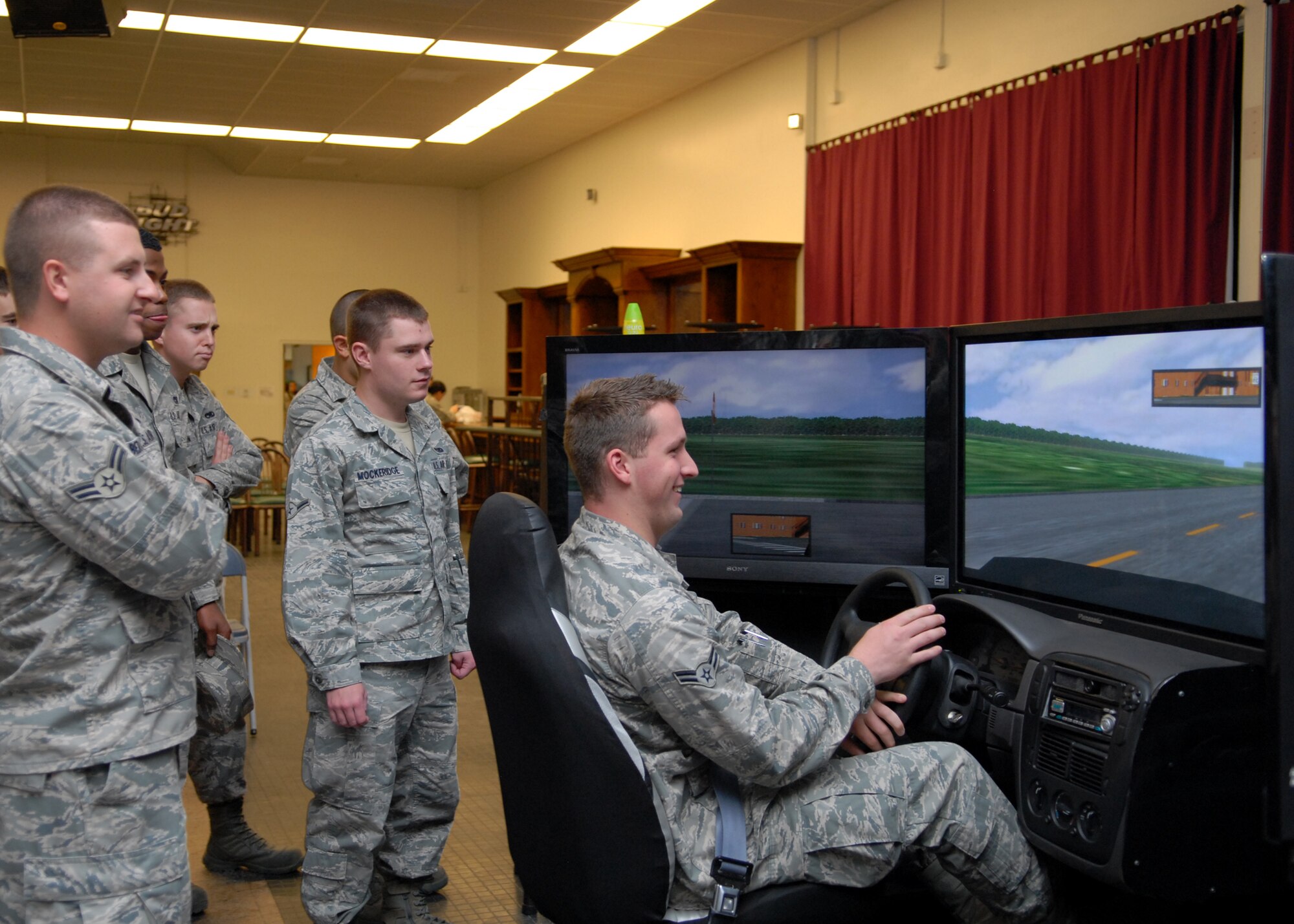 Airman 1st Class Joshua Case, 412th Aircraft Maintenance Squadron avionics specialist, "drives while impaired" on a drunk-driving simulator during the Save a Life Tour event, May 24 at the Oasis Community Center. The Save a Life Tour event kicked off the "101 Critical Days of Summer," a safety campaign that runs from Memorial Day to Labor Day and promotes the importance of being safe while taking part in summer activities. Airman Case and his "blood alcohol level" did not fare well with the simulated drive. (Air Force photo by Kate Blais)