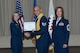 Staff Sgt. Andre Olaciregui (middle) accepts his Community College of the Air Force degree from Col. Stacy L. Yike (left), 66th Air Base Group commander, during the CCAF graduation in the Hanscom Conference Center May 5. Chief Master Sgt. Laura Noel (right), Electronic Systems Center interim command chief, provided the commencement address to the 20 Airmen receiving degrees. (U.S. Air Force photo/Rick Berry)