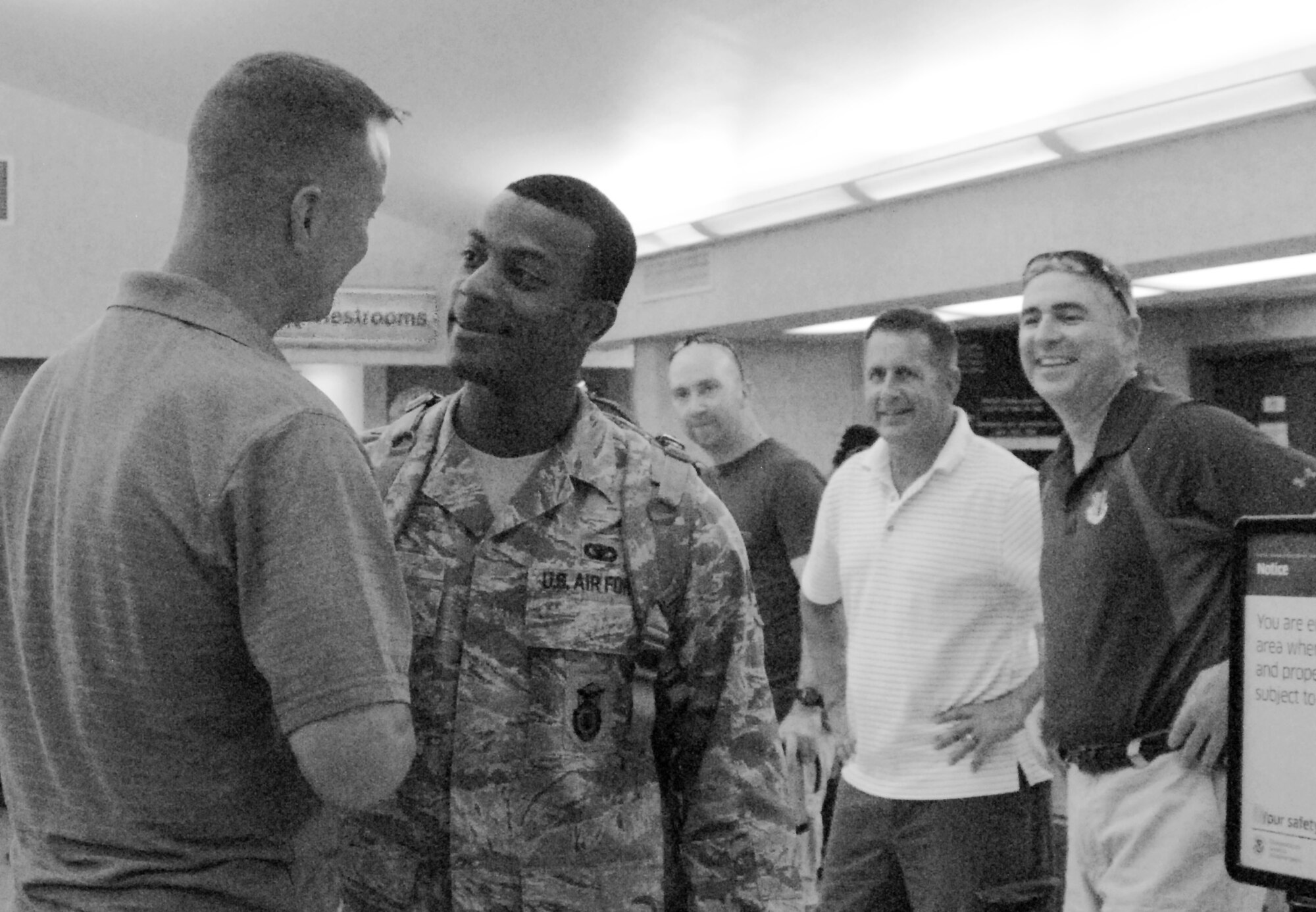 SAN ANGELO, Texas -- Senior Airman Vernon Boyd, 17th Security Forces Squadron, says goodbye to Maj.  James Masoner, 17th SFS Commander, at the San Angelo Regional Airport Sunday as (right to left) Col. Thomas Geary, 17th Training Wing Commander, Col. Paul Bugenske, 17th Mission Support Group Commander, and MSgt. Christopher Norci, 17th SFS First Sergeant, look on.  (U.S. Air Force photo/Kent Cummins)