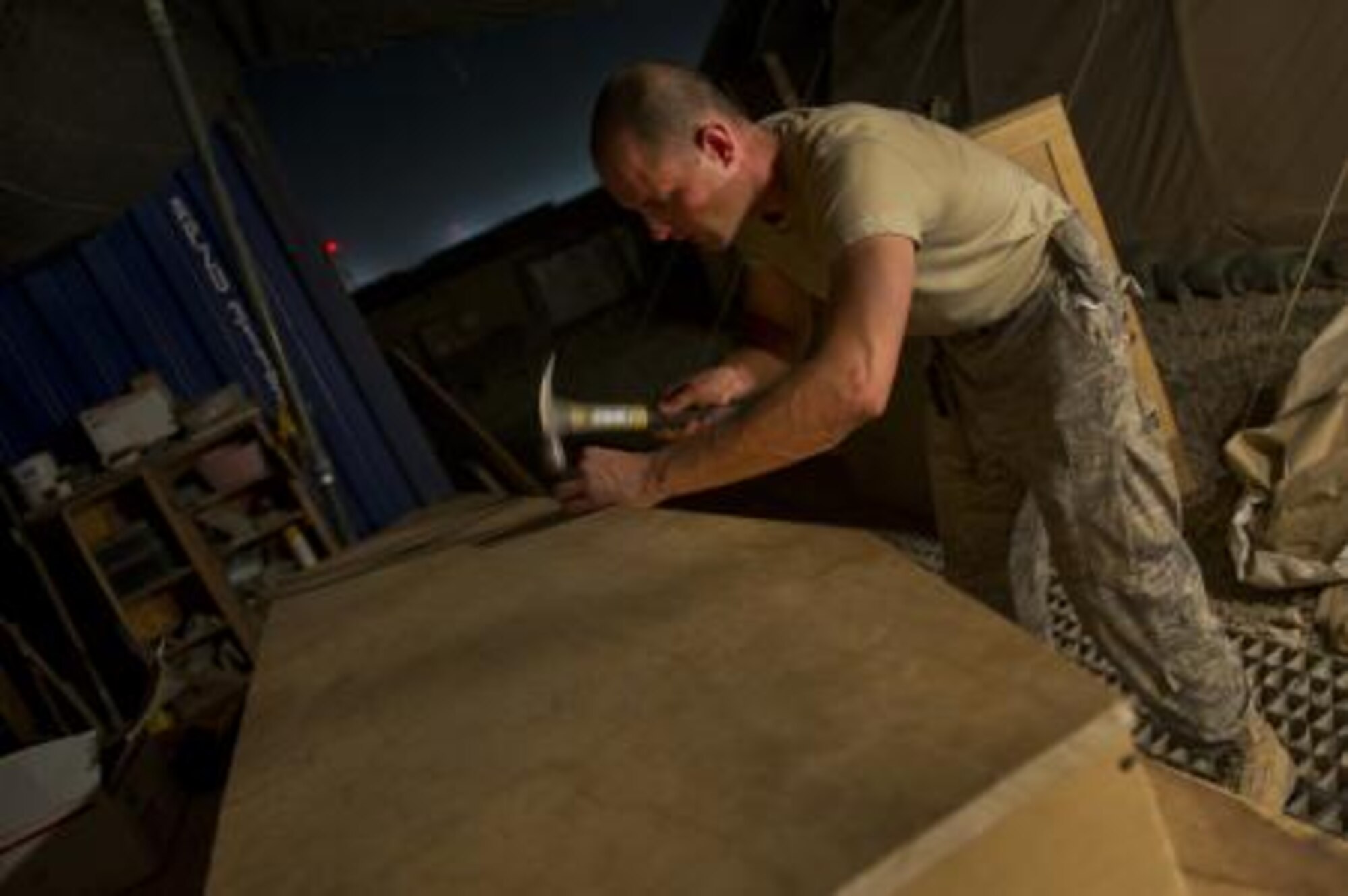 Master Sgt. Jason Reininger, 451st Expeditionary Aeromedical Evacuation Squadron Detachment 1 Contingency Aeromedical Staging Facility, aerospace medical technician, builds a child-size coffin that will be turned over to the Role 3 hospital at Camp Bastion, Afghanistan. Sergeant Reininger, a reservist deployed from the 419th Medical Squadron, volunteered to build the coffin after finding out there was a need for one. (Air Force photo/Master Sgt. Adrian Cadiz)