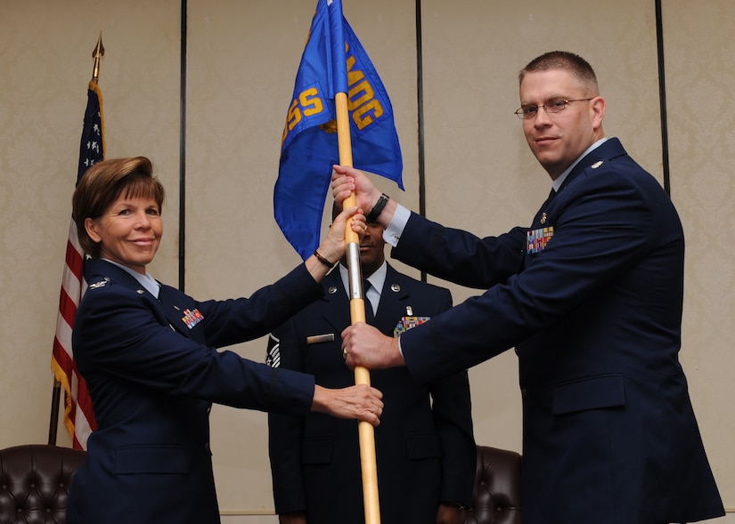 Col. Consuella Pockett passes the guide-on to Lt. Col. David Schlevensky during the 628th Medical Support Squadron Change of Command at Joint Base Charleston Jun. 1. Colonel Pockett is the 628th Medical Group commander and Colonel Schlevensky is the 628 MDSS commander. (U.S. Air Force photo/Staff Sgt. Katie Gieratz