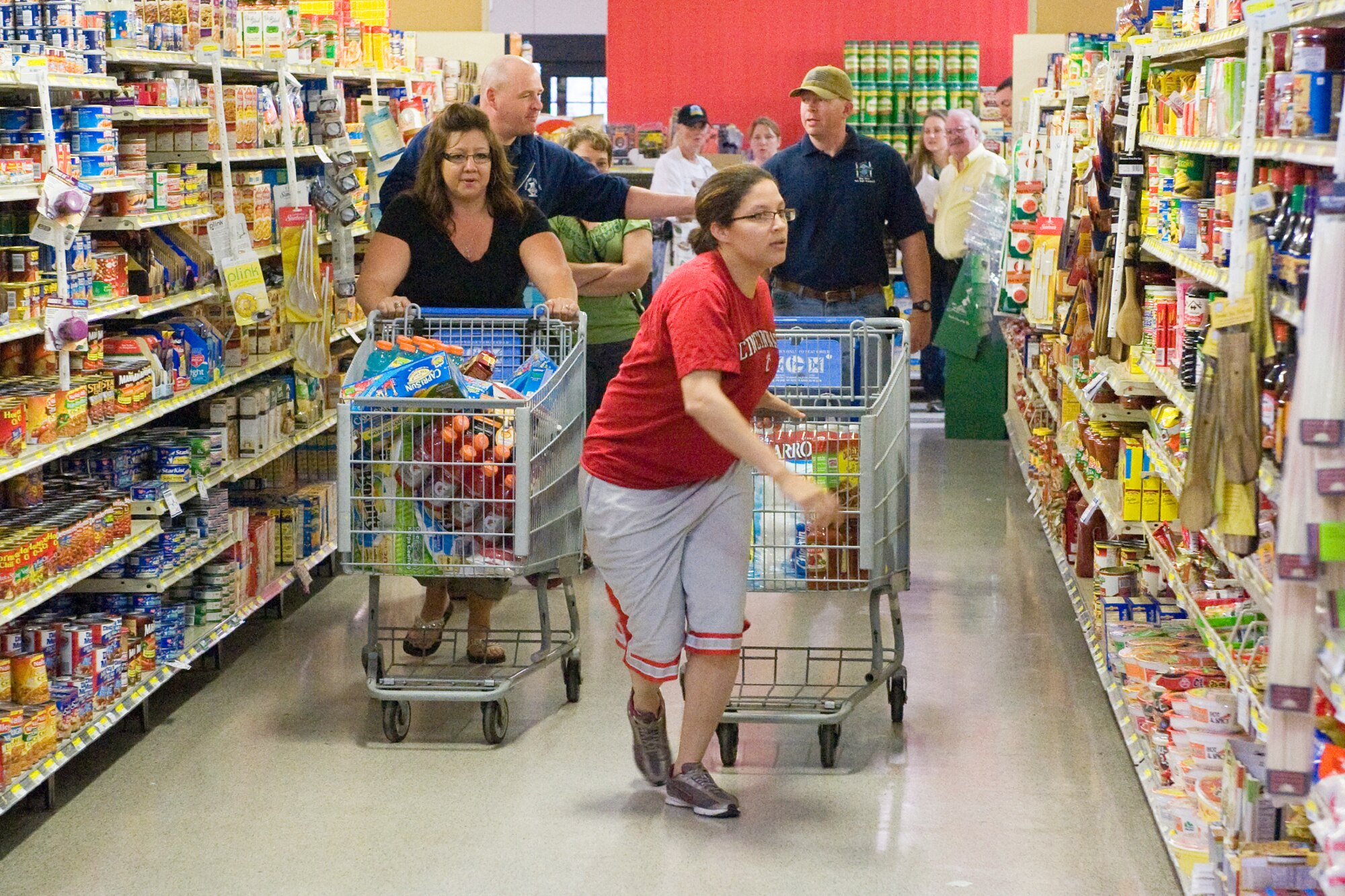 Staff Sgt. Kathy Kroeger tries to spend the $200 shopping spree she won a the Deployed Spouse's Night event at the Commissary May 23. Sergeant Kroeger is a member of the 341st Missile Security Forces Squadron. (U.S. Air Force photo/Beau Wade)