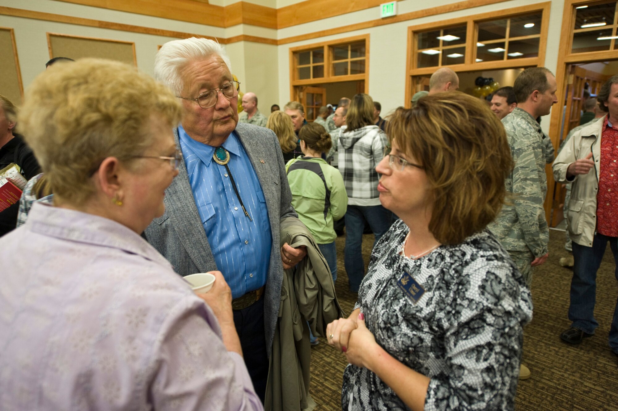 Retired community members Penny and Steve Kubick chat with Cheryl Ulmer, Senator Jon Tester’s field representative, after the ribbon cutting for the new community activities center.  Mr. Kubick is also the former CEO of 1st Liberty Federal Credity Union. (U.S. Air Force photo/John Turner)