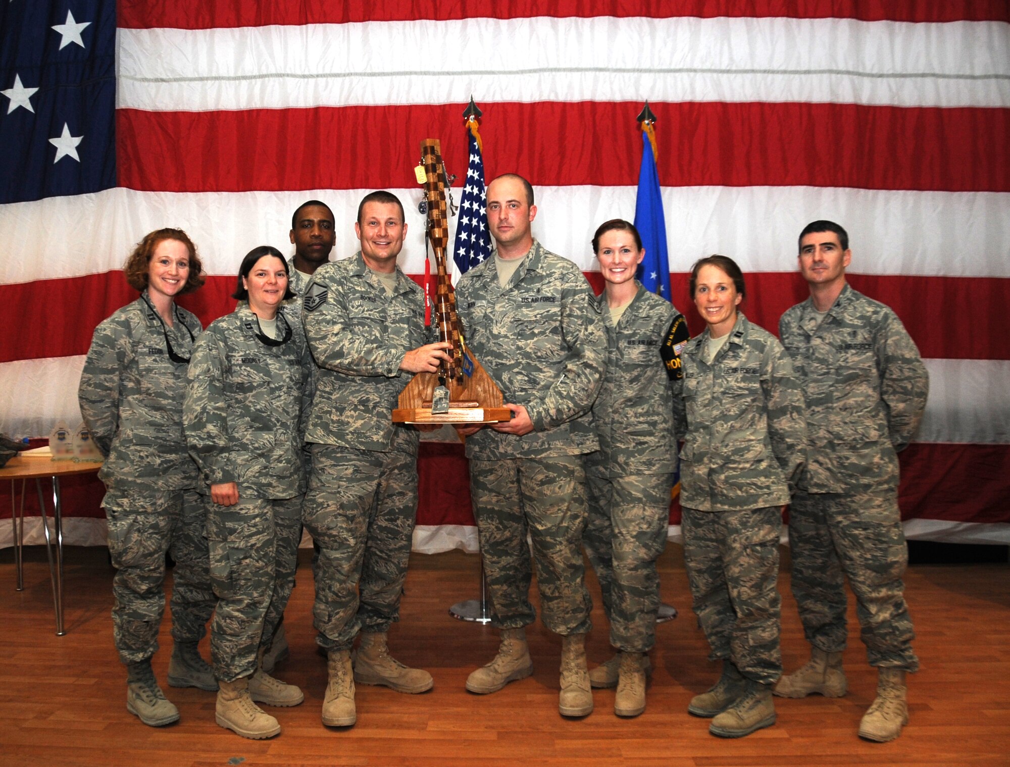The 386th Expeditionary Medical Group logged two wing-wide awards winners at the 386th Air Expeditionary Wing's monthly awards assembly June 1. The 386th EMDG also captured the wing spirit award. Pictured from left: Capt. Amy Fedor; Capt. Rebekah Mooney; 1st Lt. Gaylon Gray, Master Sgt. Walter Booker; Staff Sgt. Robert Brown III, 386th Noncommissioned Officer of the Month; Senior Airman Breanna Nygren, 386th Airman of the Month; Capt. Vivien Miller; and Col. Brian Stanton, 386th EMDG commander. (U.S. Air Force photo by Senior Airman Cynthia Spalding)