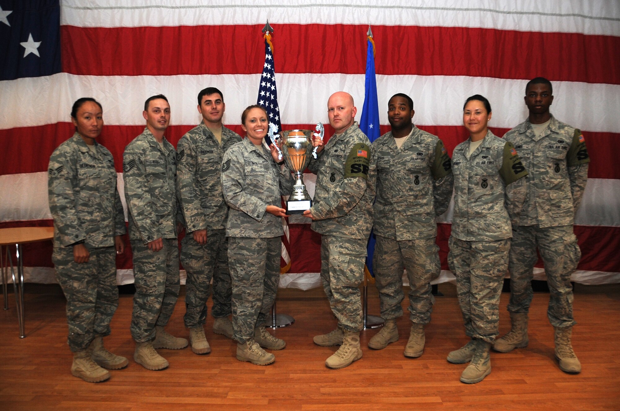 The 386th Air Expeditionary Wing's Outstanding Team of the Month poses for a photograph following an awards ceremony June 1. The 387th Expeditionary Security Forces Squadron Bravo Flight of the 387th Air Expeditionary Group earned the accolade. Pictured from left: Senior Airman Octavia Silentman, Staff Sgt. Aaron Dieringer, Staff Sgt. Geoff Bug, Tech Sgt. Tisha Bate, Tech Sgt. Chad Knox, Airman 1st Class Charles Lewis, Senior Airman Jennifer Kingshot and Senior Airman Christopher Jones. (U.S. Air Force photo by Senior Airman Cynthia Spalding)