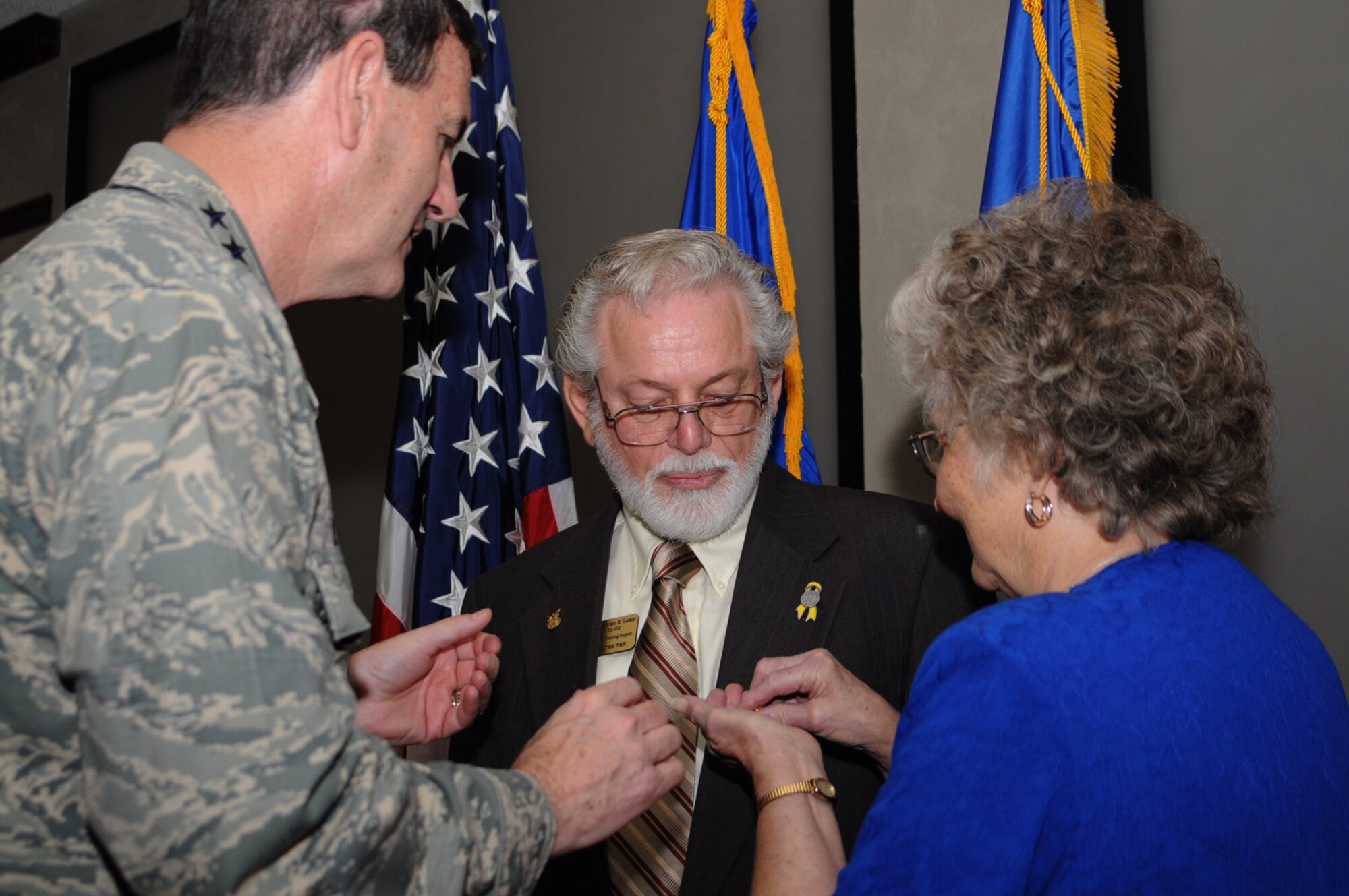 Gen. Stephen Lorenz, left, former commander of Air Education and Training Command, presents Mr. Lamm a pin recognizing 50 years of federal service during the general’s visit to Keesler, Aug. 21, 2008. Also pictured is Mr. Lamm’s wife, Barbara Ann.  (U.S. Air Force photo by Kemberly Groue)