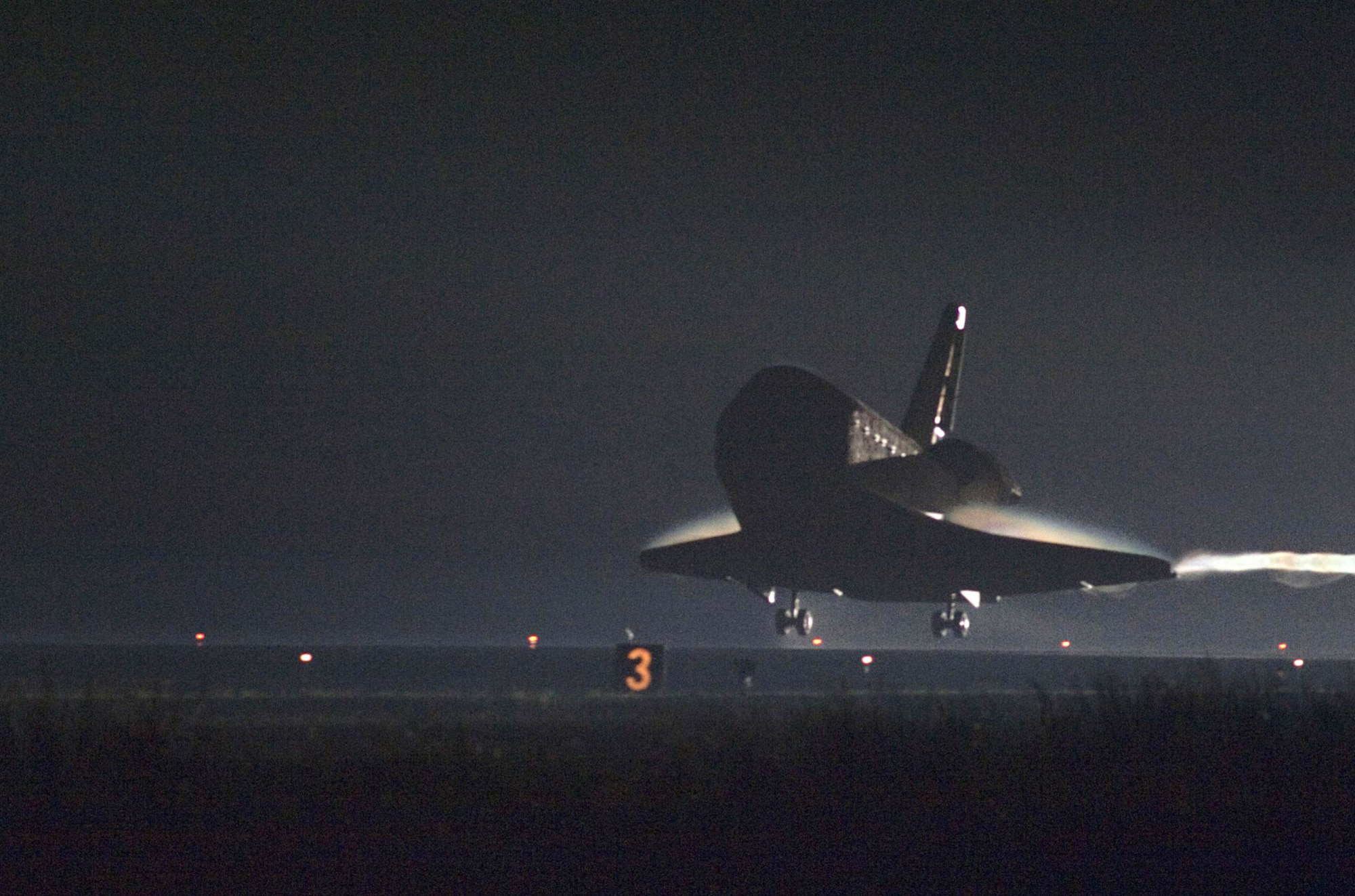 A vapor trail follows space shuttle Endeavour as it approaches Runway 15 on the Shuttle Landing Facility at NASA's Kennedy Space Center in Florida for the final time. Endeavour landed June 1, 2011, at 2:35 a.m. EDT, wrapping up the STS-134 mission. During the 16-day mission, Commander Mark Kelly and crew delivered the Alpha Magnetic Spectrometer to the International Space Station.  (NASA photo/Chuck Tintera)