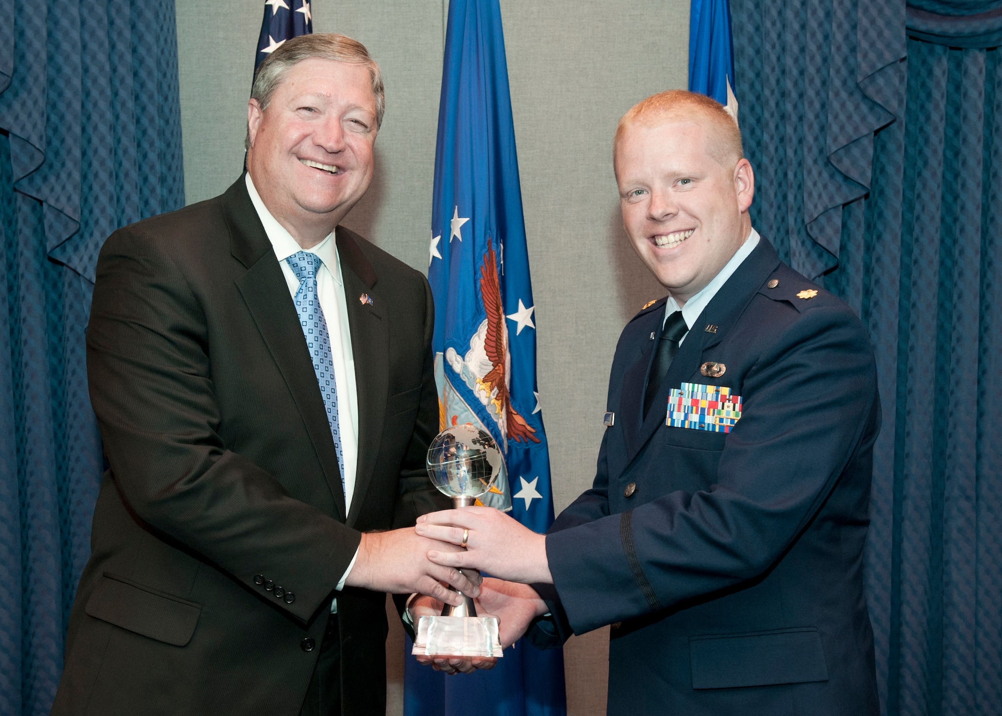 Secretary of the Air Force Michael Donley presents Maj. Paul Sebold with the Air Force International Affairs Excellence Award for 2010 during a ceremony May 31, 2011, in the Pentagon. Established in 2008, the annual award recognizes the Air Force member who is judged to most effectively build, sustain, expand and guide enduring international relationships. Major Sebold is assigned to Headquarters U.S. Air Forces in Europe at Ramstein Air Base, Germany, as a political military affairs strategist and country desk officer. (U.S. Air Force photo/Jim Varhegyi)