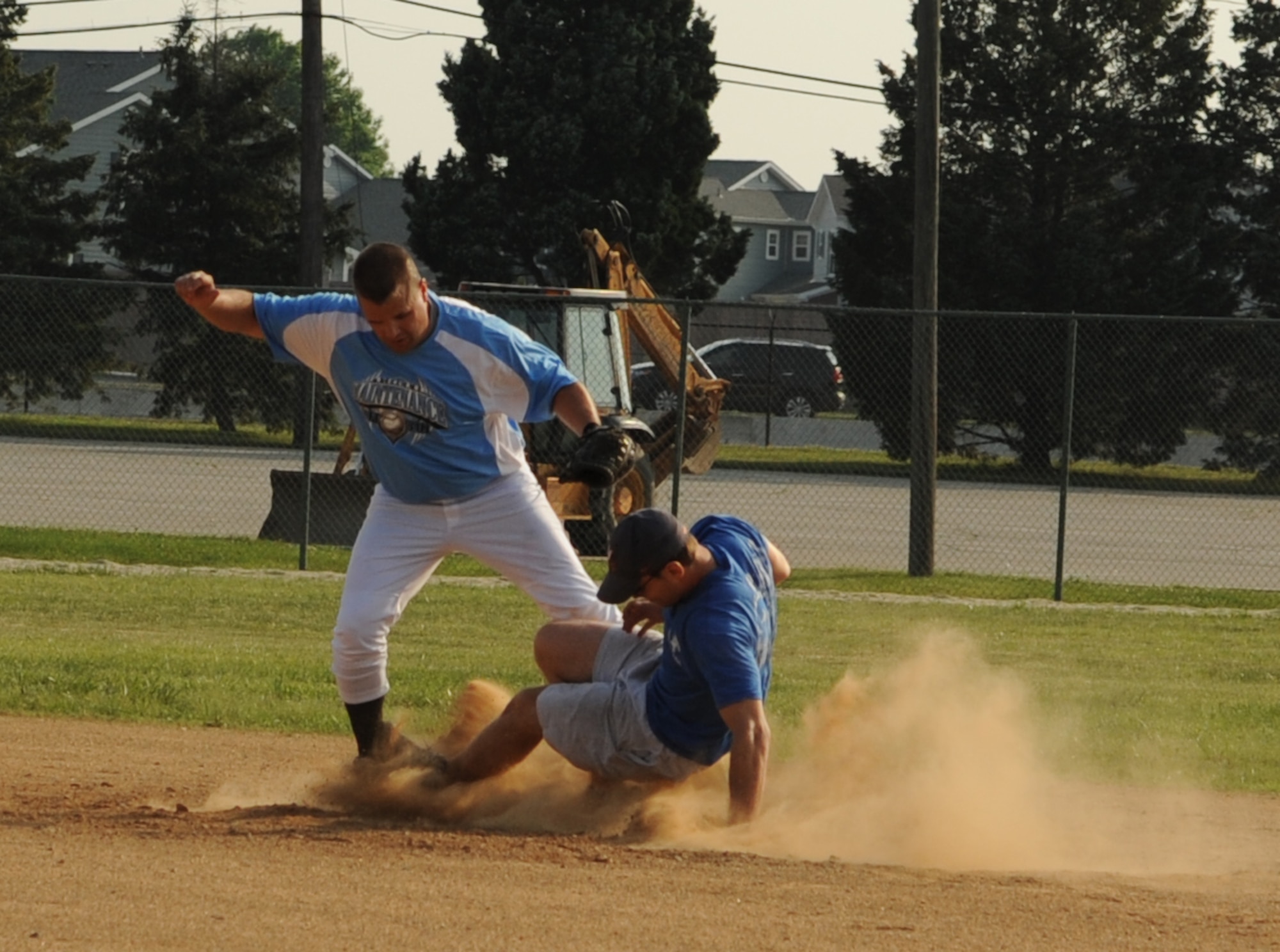Vincent Alois, 436th Maintenance Squadron second baseman, forces out Brian Reynolds, 9th Airlift Squadron, during the first softball game of the season May 31, 2011.  436 MXS A defeated 9 AS with a final score of 19 – 9.  (U.S. Air Force photo by Staff Sgt. Chad Padgett)