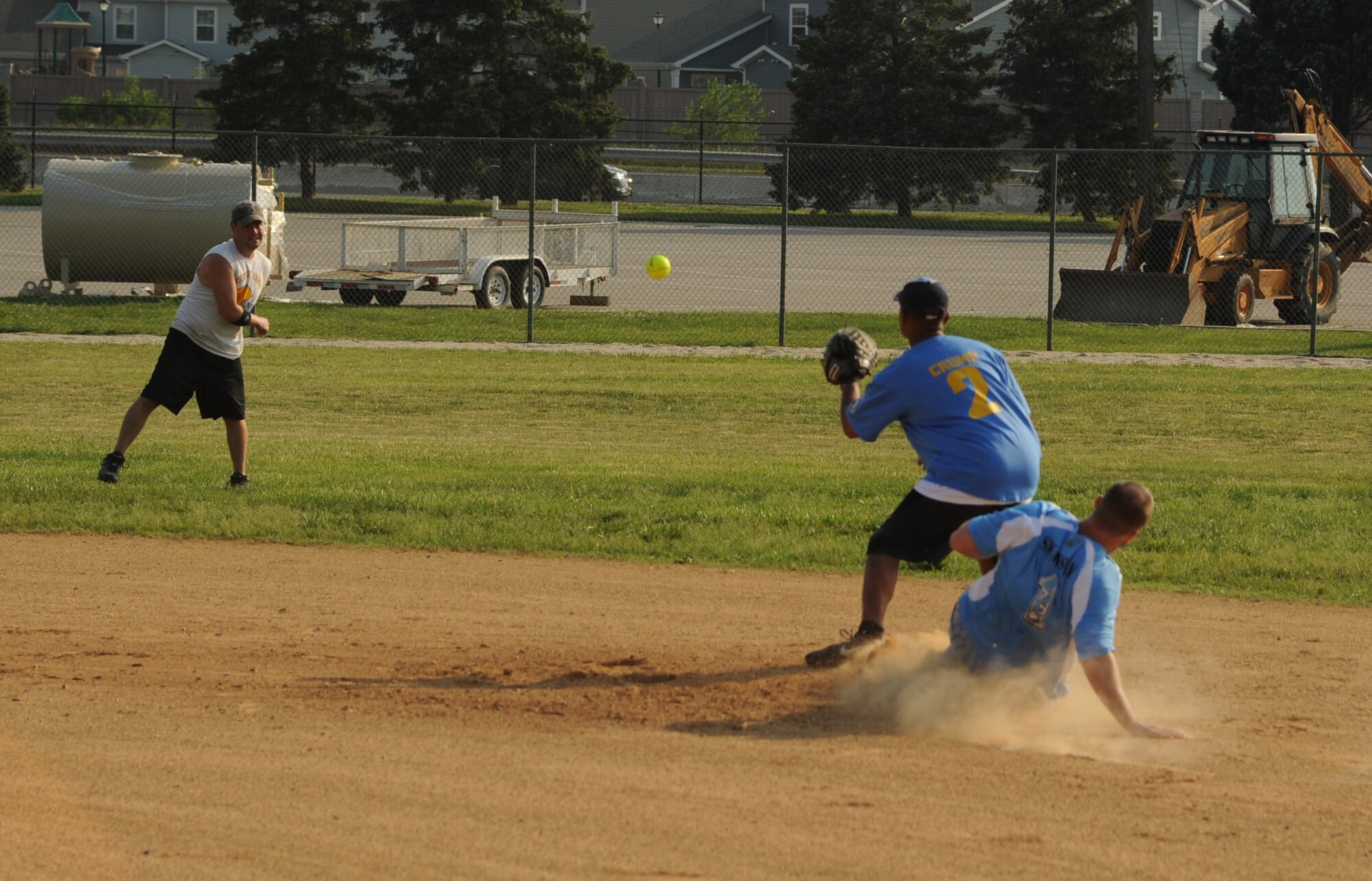 Eric Swanson, 436th Maintenance Squadron left center, slides into second ahead of the ball thrown by Justin Leonard, 9th Airlift Squadron shortstop, to Johnny Crump, 9 AS second baseman.  436 MXS A defeated 9 AS with a final score of 19 – 9.  (U.S. Air Force photo by Staff Sgt. Chad Padgett)