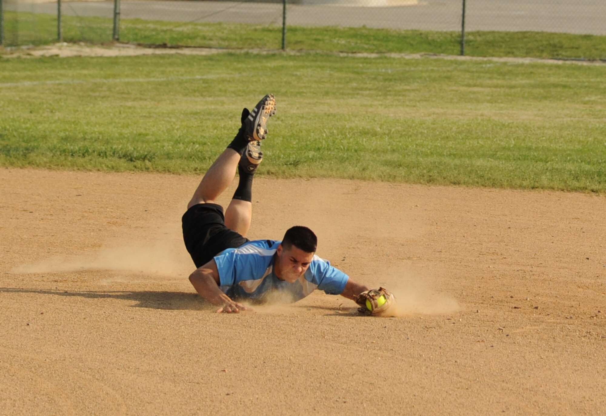 Joseph Perez, 436th Maintenance Squadron shortstop, makes a diving catch in the first inning against the 9th Airlift Squadron.  436 MXS A defeated 9 AS with a final score of 19 – 9.  (U.S. Air Force photo by Staff Sgt. Chad Padgett)