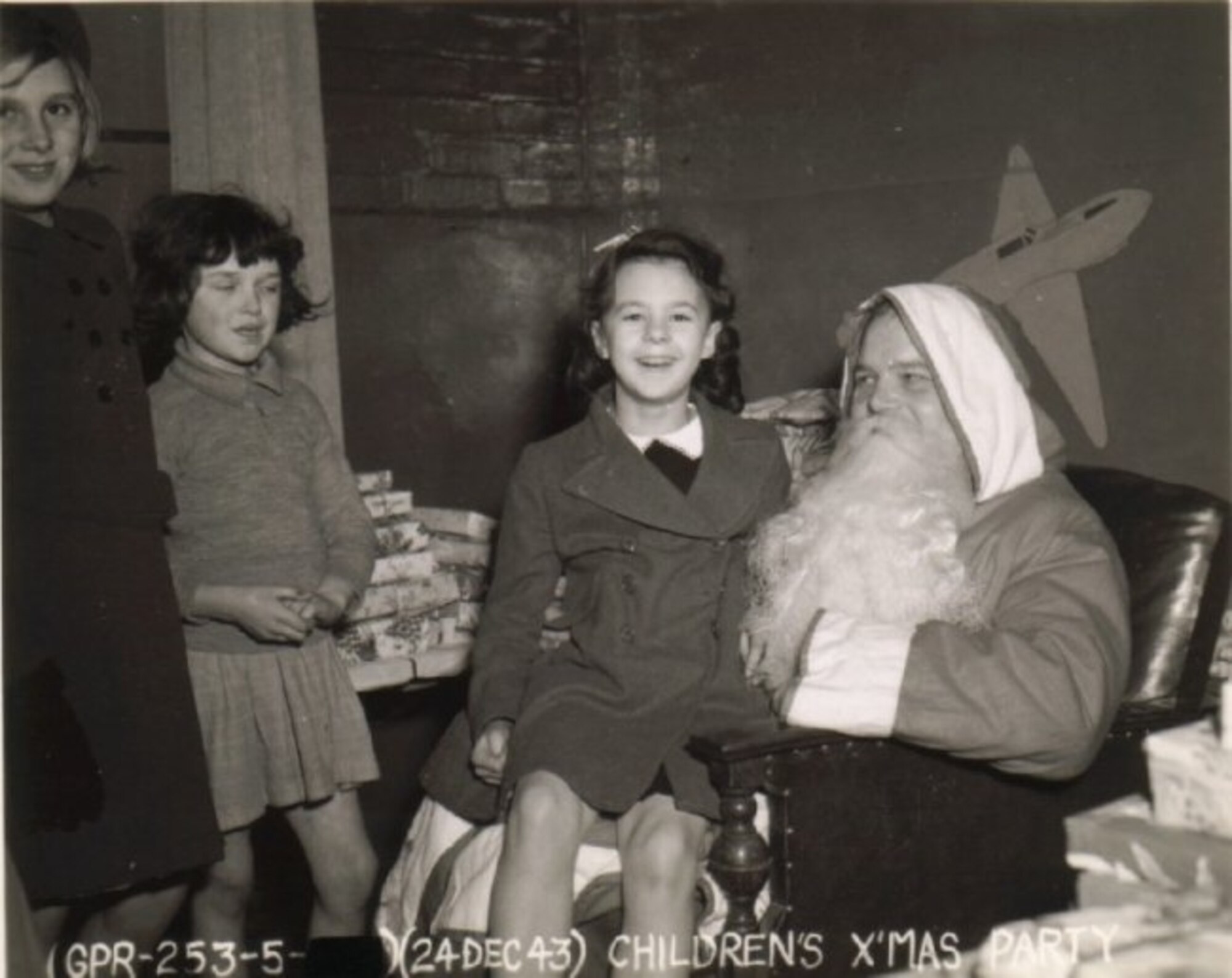 British Children at a 303rd Bomb Group children's party at Molesworth in December 1943 enjoying treats such as Hershey chocolate bars and ice cream rarely seen due to rationing during wartime Britain (Photo 303rd BGA)