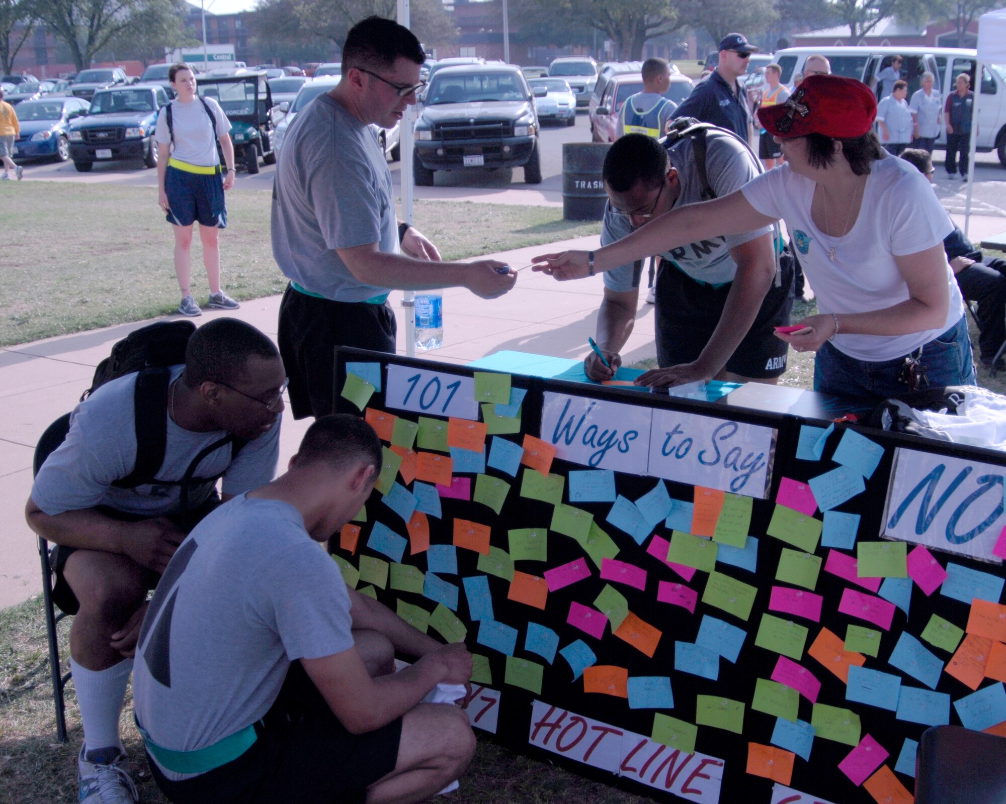GOODFELLOW AIR FORCE BASE, Texas -Lori Matus, assistant to the Goodfellow Sexual Assault Response Coordinator, helps Soldiers with the 344th Military Intelligence Battalion post their reasons to say no to sex at the Sexual Assault Response Coordinator's booth during Safety Day May 27. Servicemembers wrote and attached ways to say no to sex in an effort to raise awareness and educate others about unsafe situations and high risk behaviors that can lead to sexual assault (U.S. Air Force photo/Tech. Sgt. Jon DuMond)

