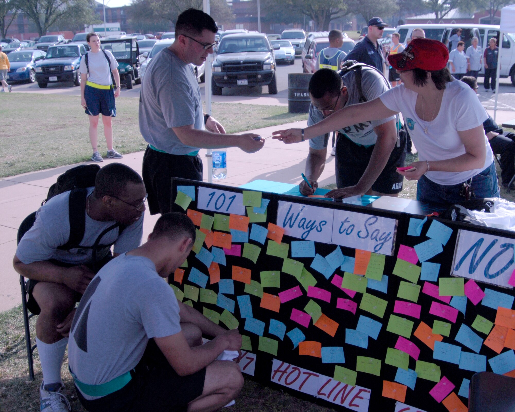 GOODFELLOW AIR FORCE BASE, Texas -Lori Matus, assistant to the Goodfellow Sexual Assault Response Coordinator, helps Soldiers with the 344th Military Intelligence Battalion post their reasons to say no to sex at the Sexual Assault Response Coordinator's booth during Safety Day May 27. Servicemembers wrote and attached ways to say no to sex in an effort to raise awareness and educate others about unsafe situations and high risk behaviors that can lead to sexual assault (U.S. Air Force photo/Tech. Sgt. Jon DuMond)

