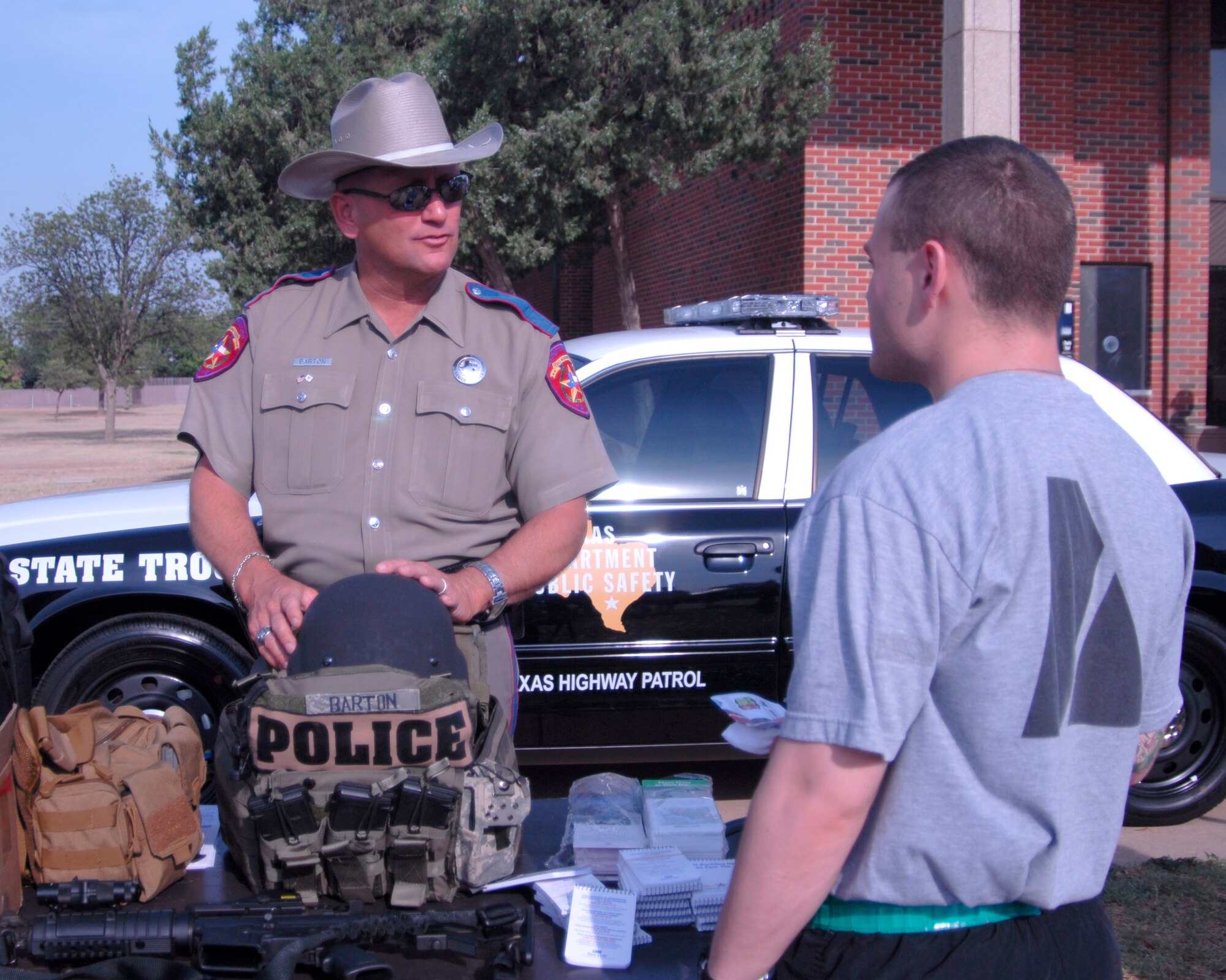 GOODFELLOW AIR FORCE BASE, Texas - Senior Trooper John Barton (left) from the Texas Highway Patrol speaks to Spc. Robert Murtha, a student with the 344th Military Intelligence Battalion, about road awareness during Safety Day activities at May 27. The THP works to maintain safety on the roads through the use of education and awareness programs. (U.S. Air Force photo/Tech. Sgt. Jon DuMond)

