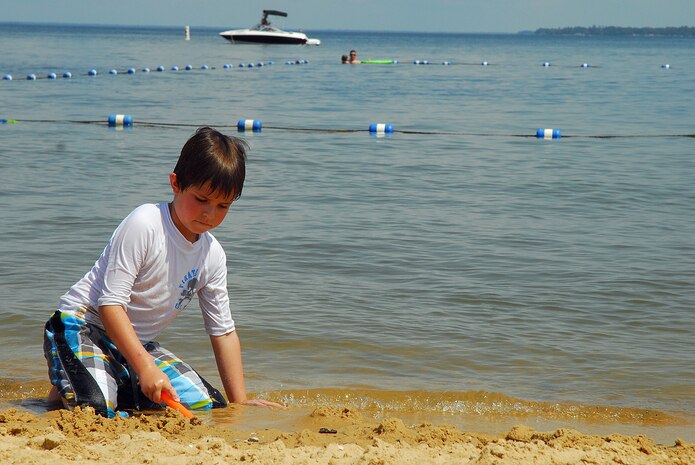 Six year-old Daniel O'Connell, son of Army National Guard Capt. John O'Connell, digs in the sand at Short Stay Navy Outdoor Recreation Area on Lake Moultrie near Moncks Corner, S.C. May 28.  Memorial Day weekend at Short Stay offered line dancing lessons, a street dance and a movie while traditional daily activities included a beach, boat rentals and picnic areas for all to enjoy.  (U.S. Navy photo/Machinist's Mate 3rd Class Brannon Deugan)
