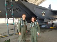 Ms. Donita Ogden, wife of Col. Randy Ogden, stands with Capt. Anthony Thompson prior to a spouse taxi in the F-15E on May 26, 2011. (USAF courtesy photo)