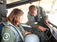 Capt. Anthony Thompson explains elements of the F-15E Strike Eagle cockpit to Ms. Donita Ogden prior to a spouse taxi on May 26, 2011. (USAF courtesy photo)