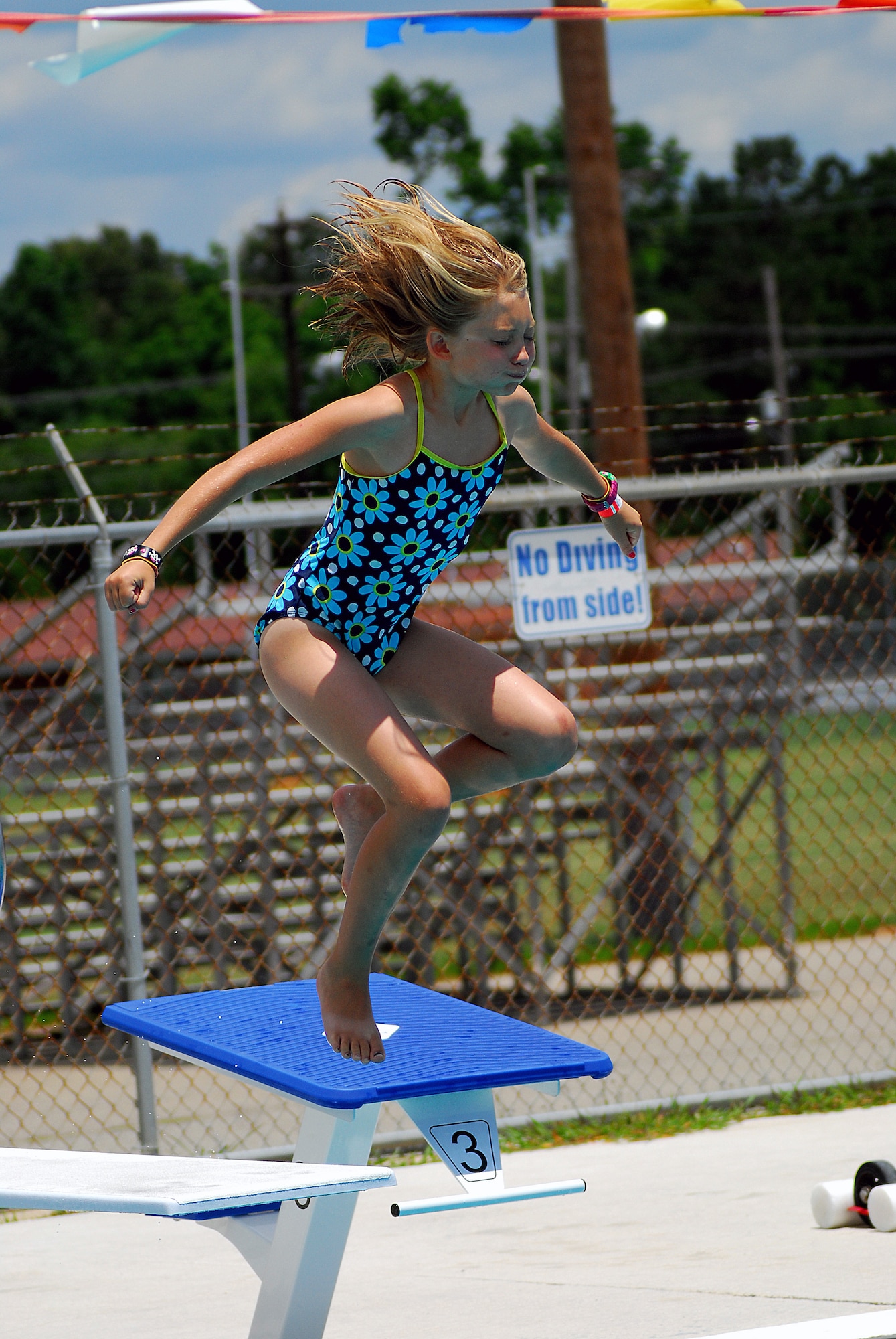 Ten year-old Angel Bolt, daughter of Machinist's Mate 1st Class Todd Bolt stationed at Nuclear Power Training Unit, jumps off the diving board at Joint Base Charleston-Weapons Station’s New Wave Aquatic Center, May 29.  The base pools on the Weapons Station and the Air Base opened for Memorial Day weekend and will provide active duty service members, retired military, reservists, DoD personnel and DoD contractors a chance to enjoy the water and the sunshine all summer long.  (U.S. Navy photo/ Machinist’s Mate 3rd Class Brannon Deugan)
