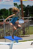 Ten year-old Angel Bolt, daughter of Machinist's Mate 1st Class Todd Bolt stationed at Nuclear Power Training Unit, jumps off the diving board at Joint Base Charleston-Weapons Station’s New Wave Aquatic Center, May 29.  The base pools on the Weapons Station and the Air Base opened for Memorial Day weekend and will provide active duty service members, retired military, reservists, DoD personnel and DoD contractors a chance to enjoy the water and the sunshine all summer long.  (U.S. Navy photo/ Machinist’s Mate 3rd Class Brannon Deugan)
