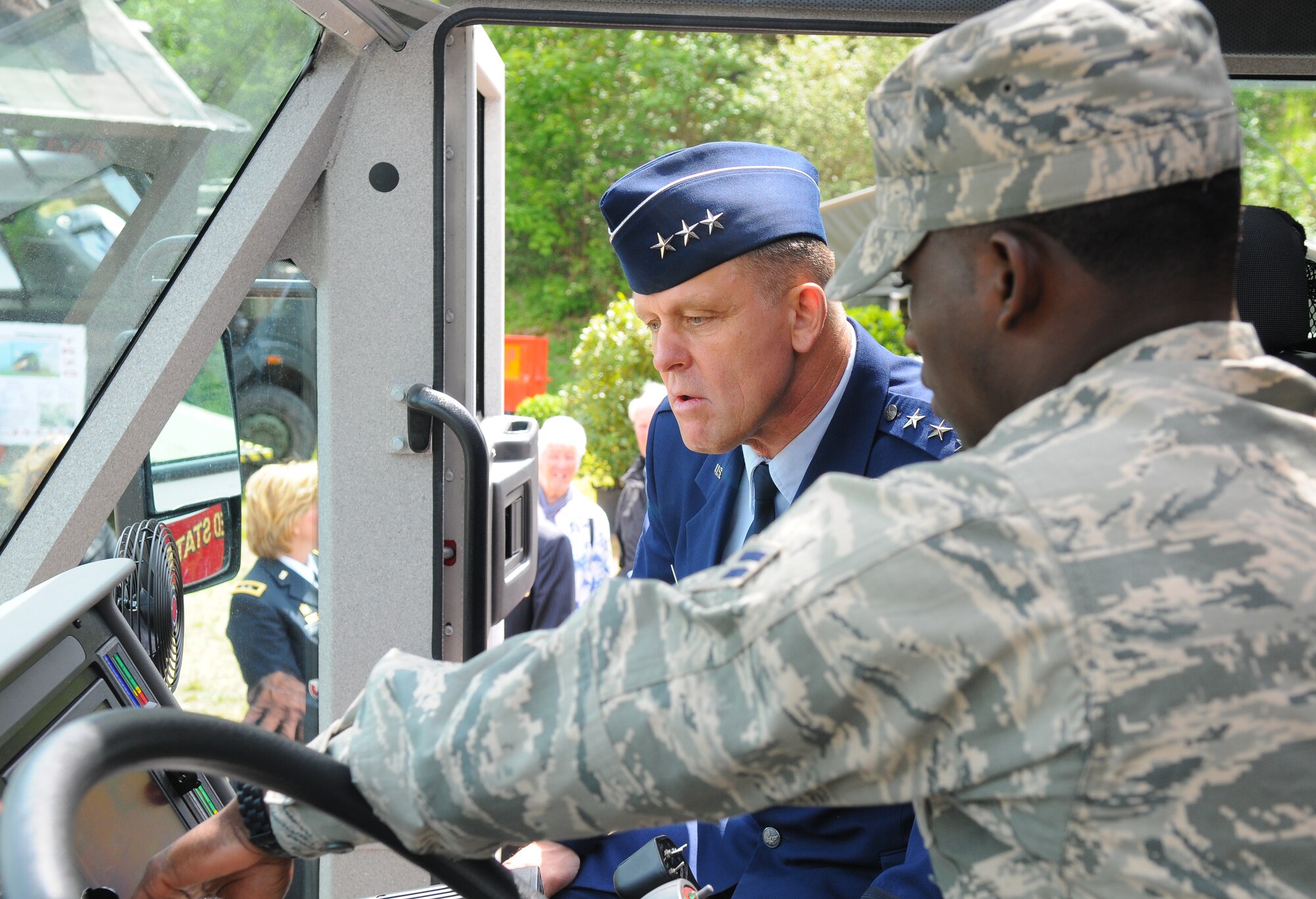 PRUEM, Germany – Airman 1st Class Jodeci Octavis Mitchell, 52nd Civil Engineer Squadron firefighter, shows Lt. Gen. Frank Gorenc, 3rd Air Force commander, how a robotic fire hose is operated from within the cab of the vehicle during the Rheinland-Pfalz Day Fair in Pruem, Germany, May 28. The Rheinland-Pfalz Day Fair is a three-day festival with entertainment, informational booths and other attractions. (U.S. Air Force photo/Airman 1st Class Dillon Davis)